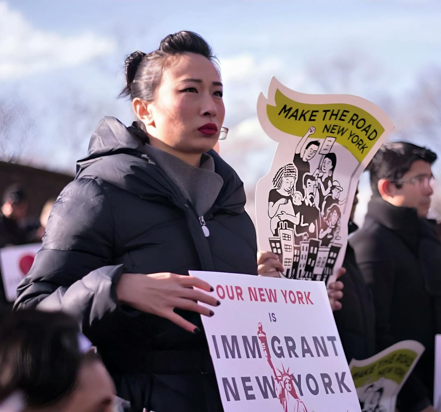 Candidate holding a sign supporting Immigrant New Yorkers