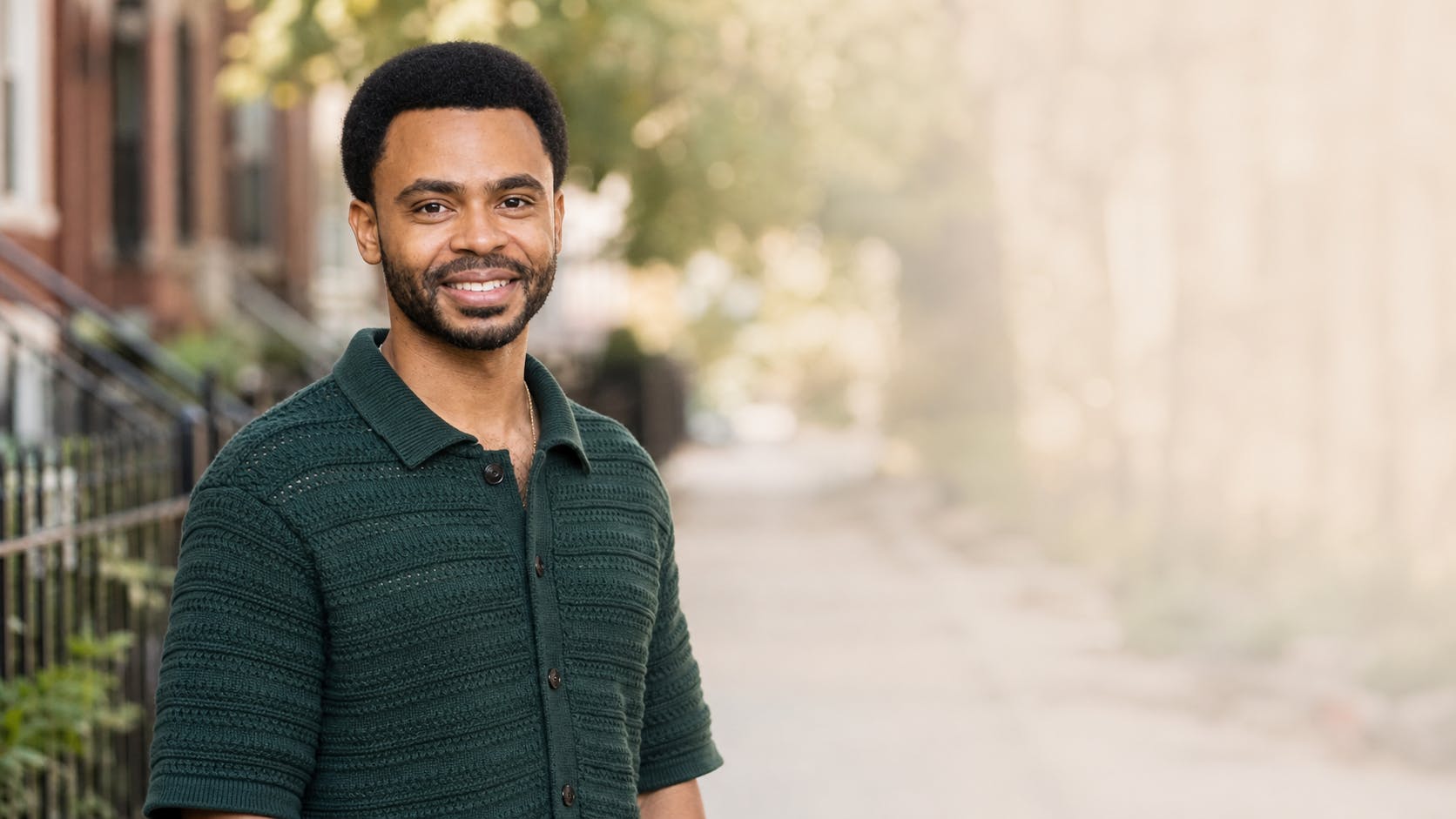 Photo of Omari leaning against his bike in Logan Square Chicago