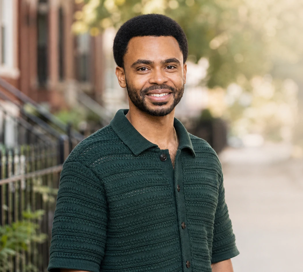 Photo of Omari leaning against his bike in Logan Square Chicago