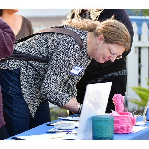 A volunteer signing up at a Linda Henigin campaign event