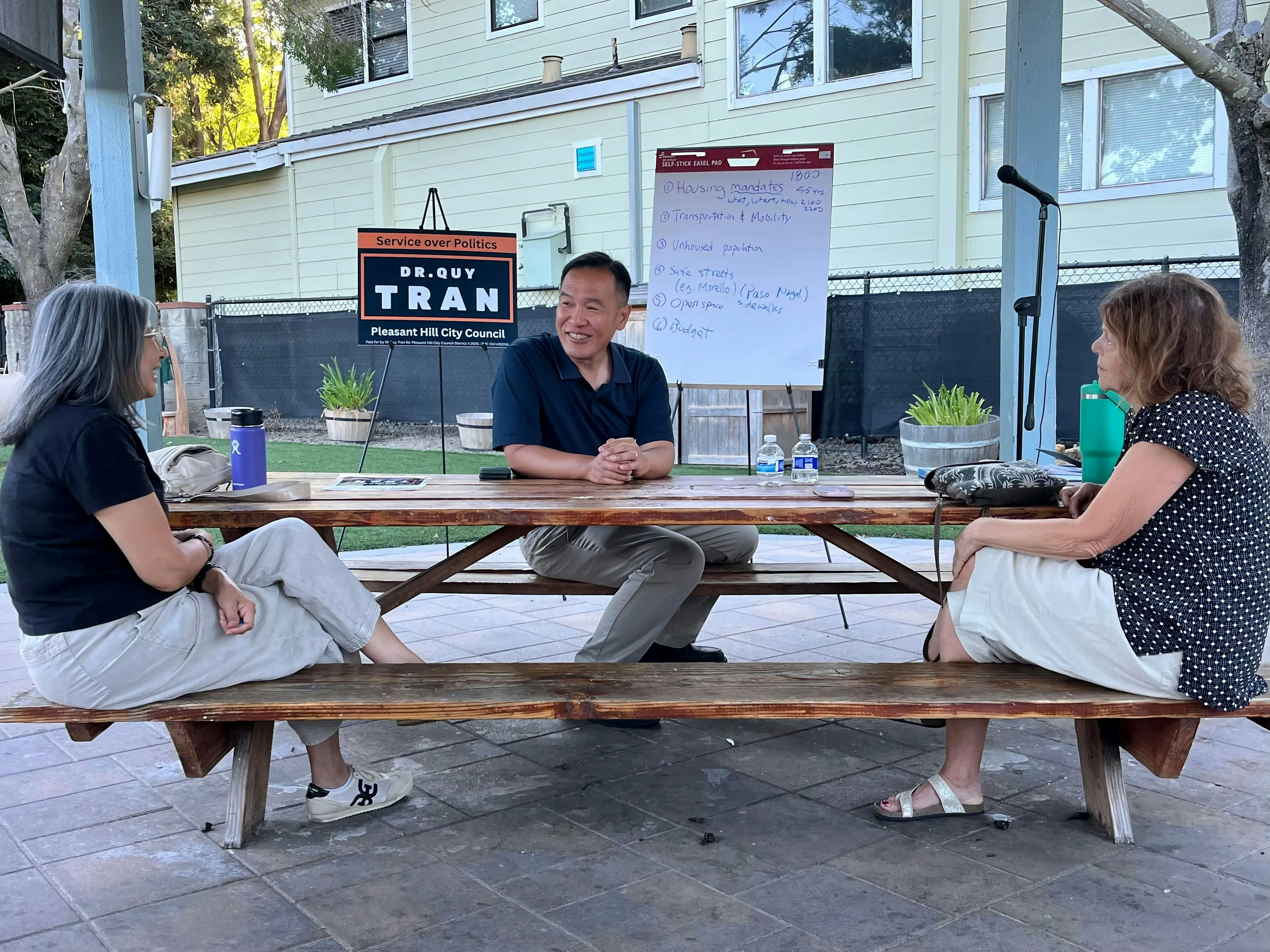 Pleasant Hill District 4 candidate Dr. Quy Tran sitting with residents of District 4 at a community townhall event.