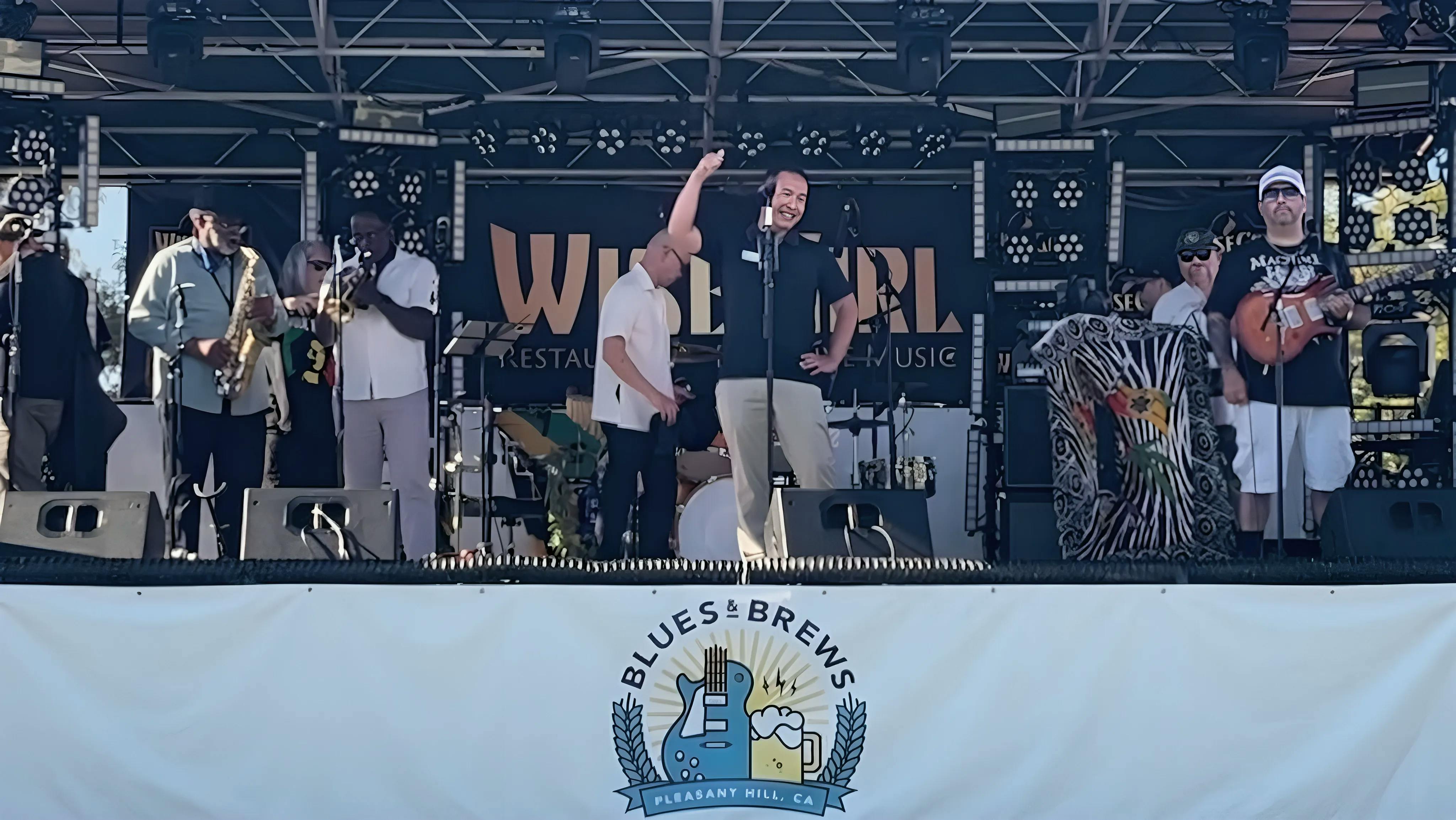 Candidate Dr. Quy Tran Introducing Musical Acts at the Pleasant Hill Blues and Brews Festival.