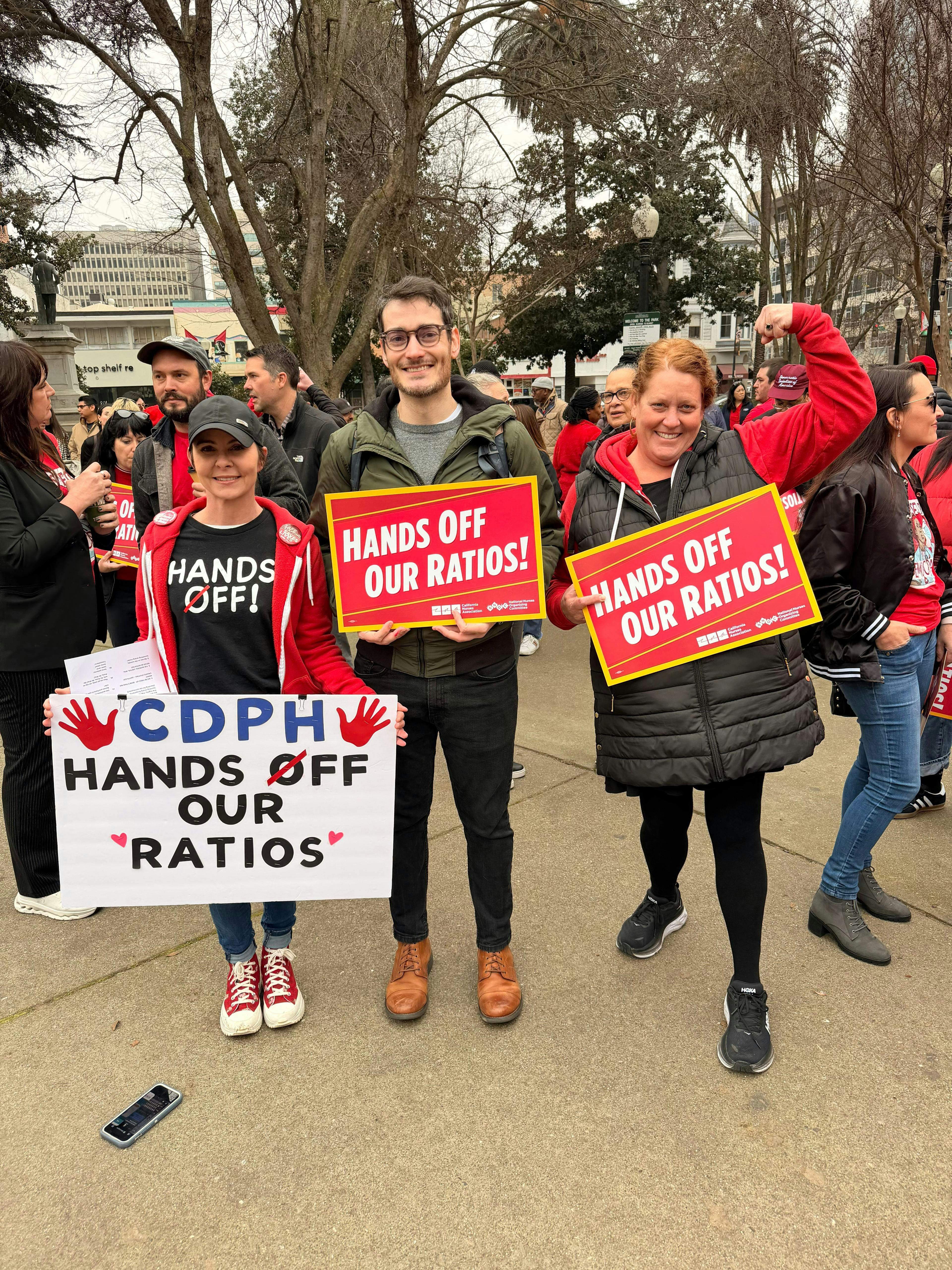 1-21-26 Chris holding a "Hands Off Our Ratios" sign with CNA nurses on Jan 21, 2026