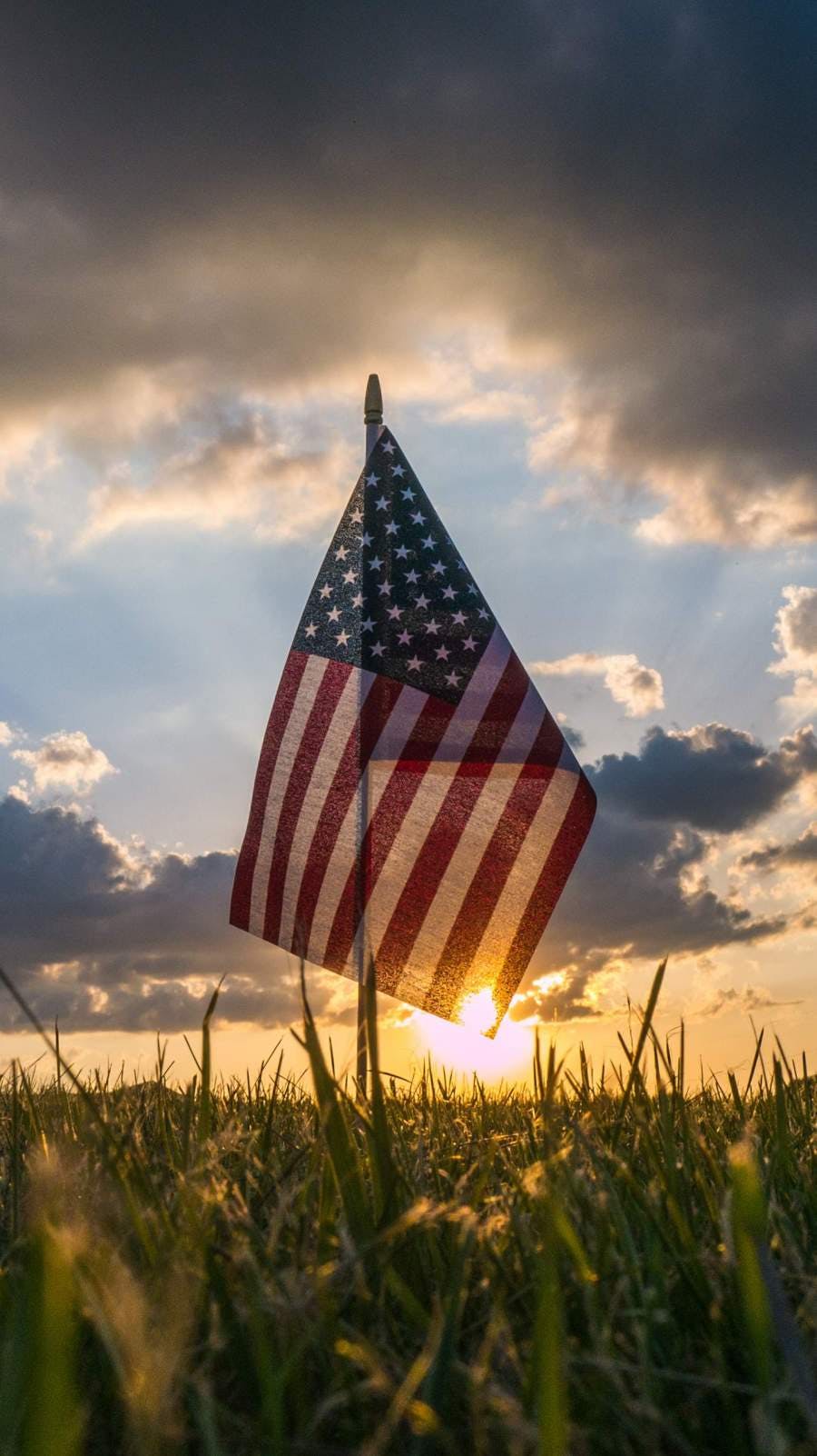 An American flag against the sunset.