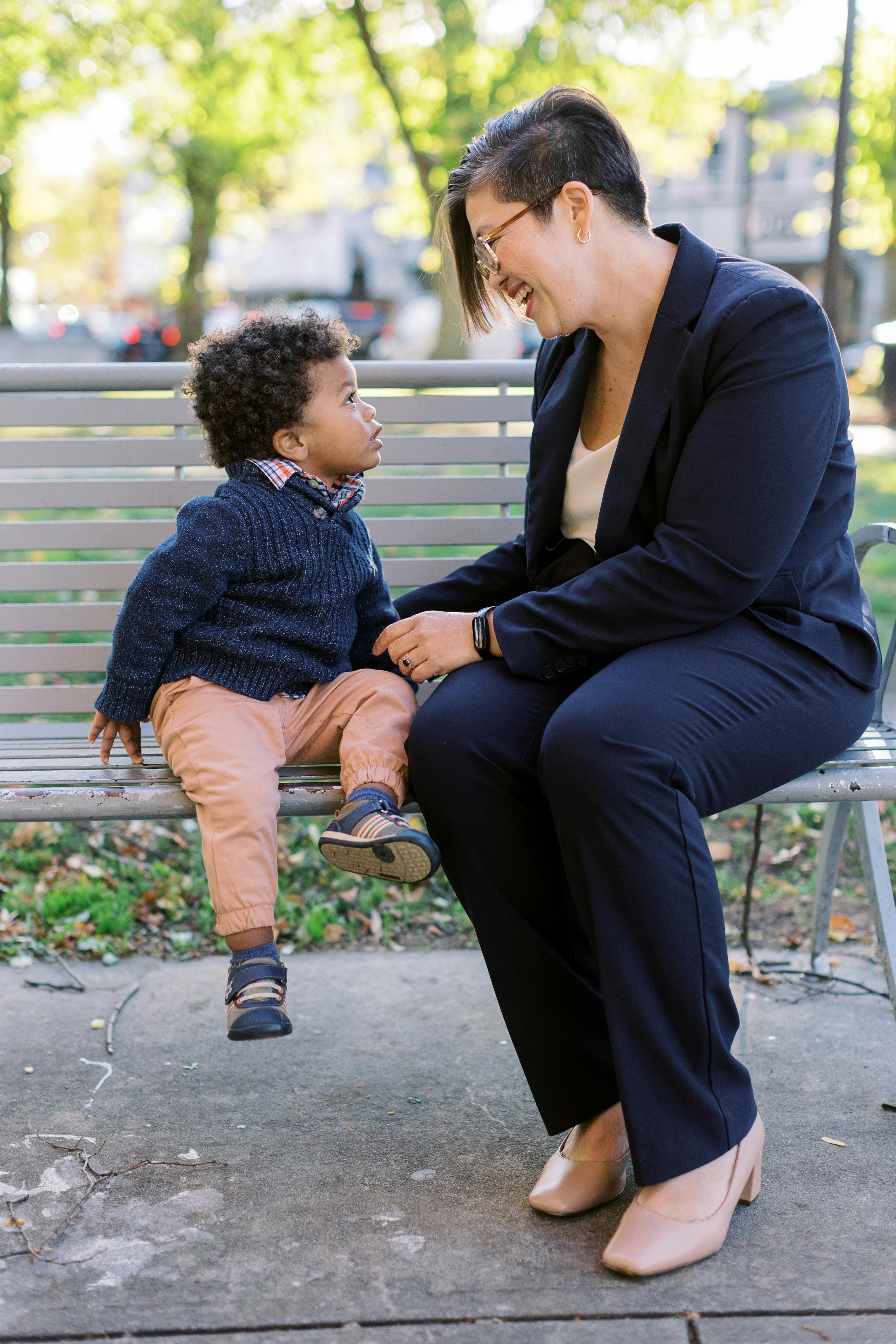 Persis with a young child on a bench