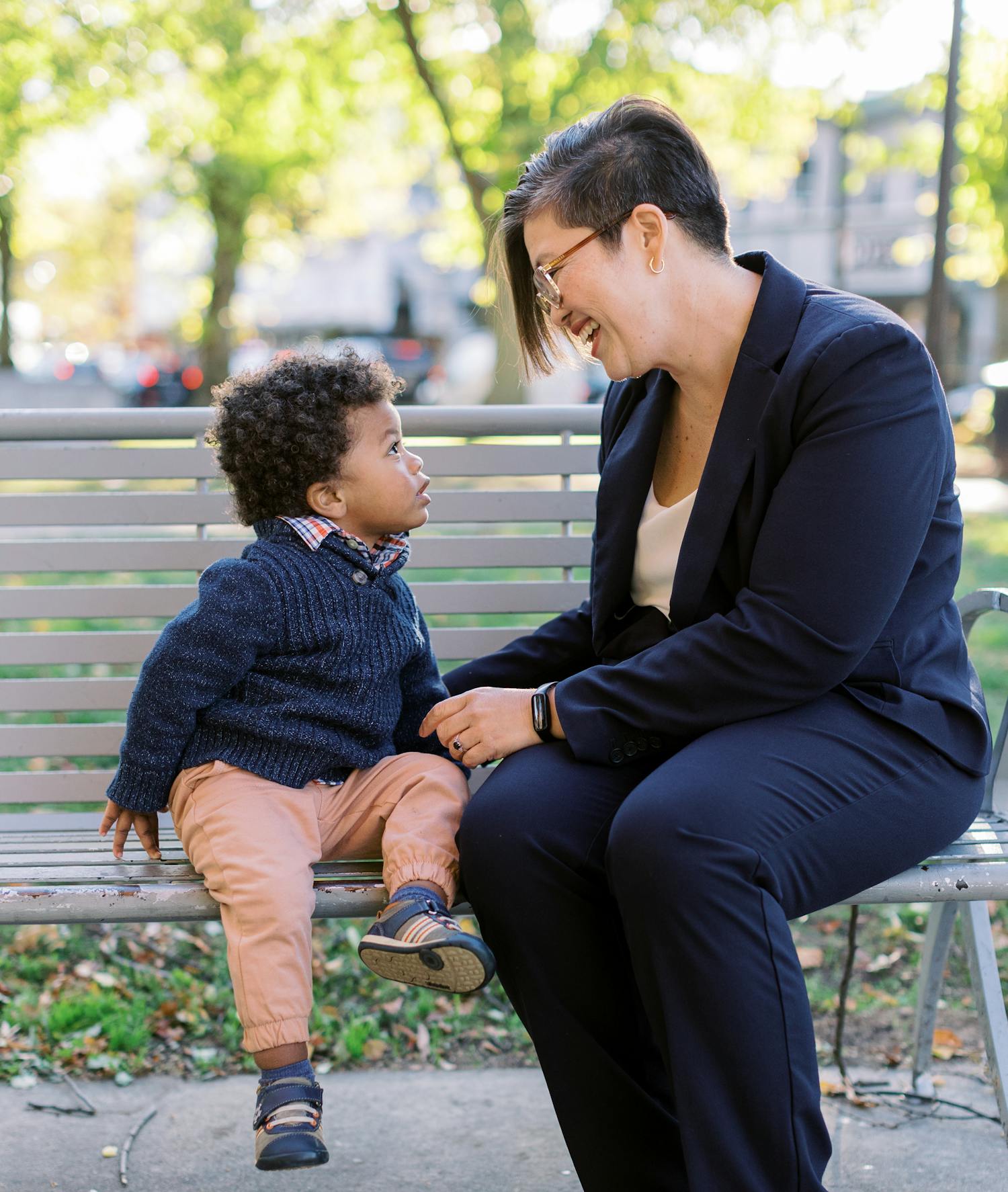 Persis with a young child on a bench