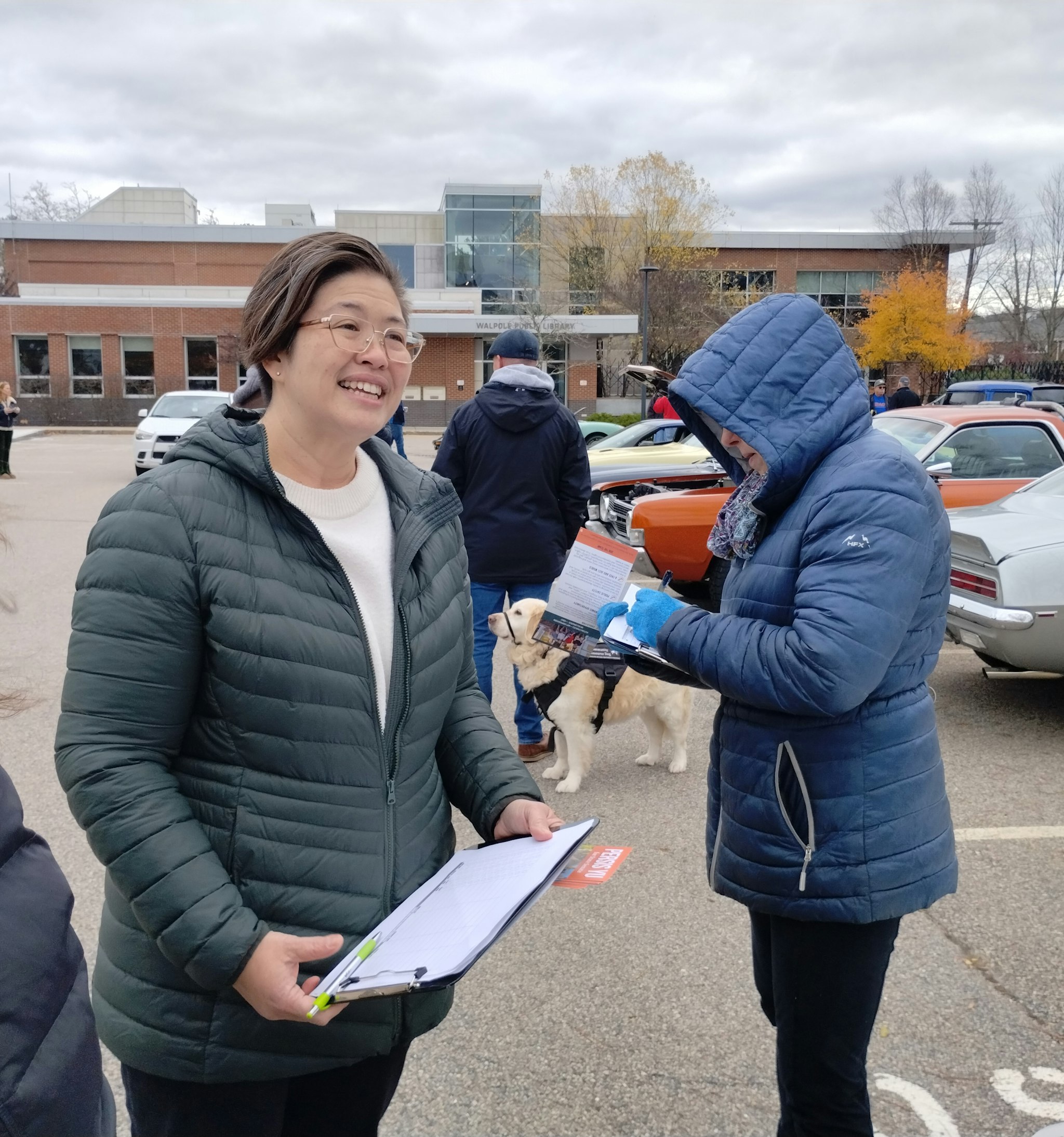 Image of Persis Yu holding a clip board to collect ballot signatures