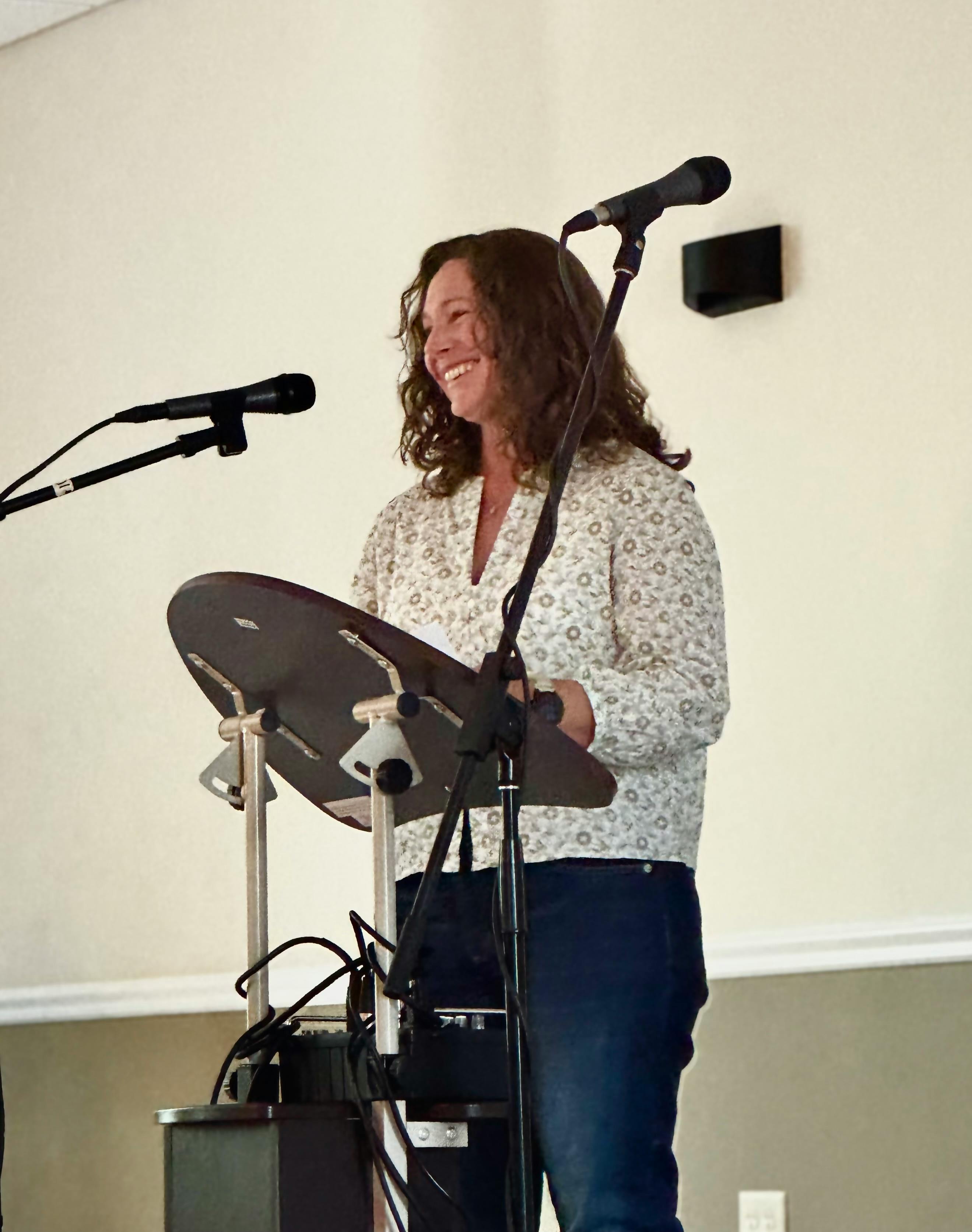 Candidate smiling in front of microphone