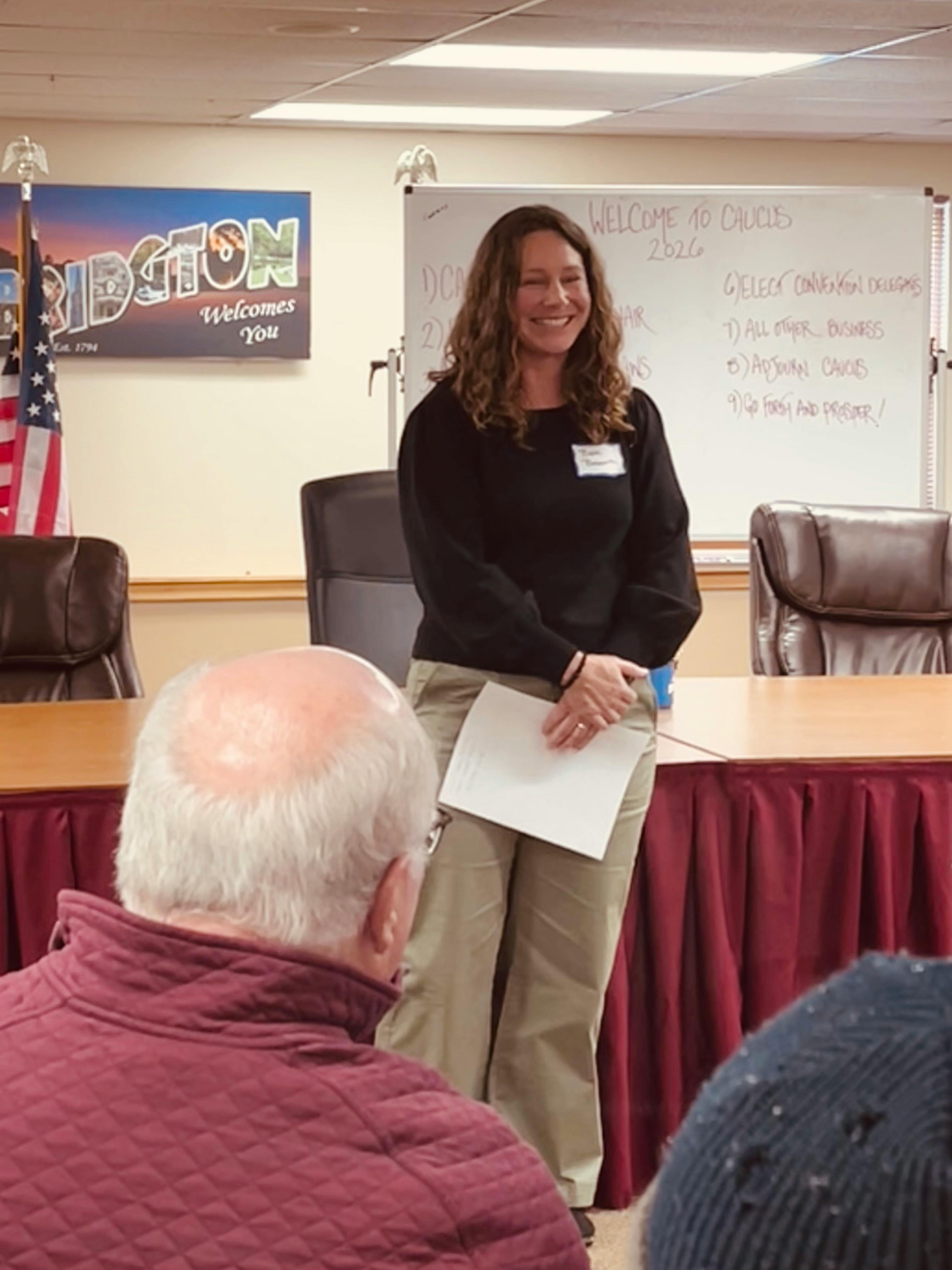 Candidate smiling in front of audience at Bridgton caucus