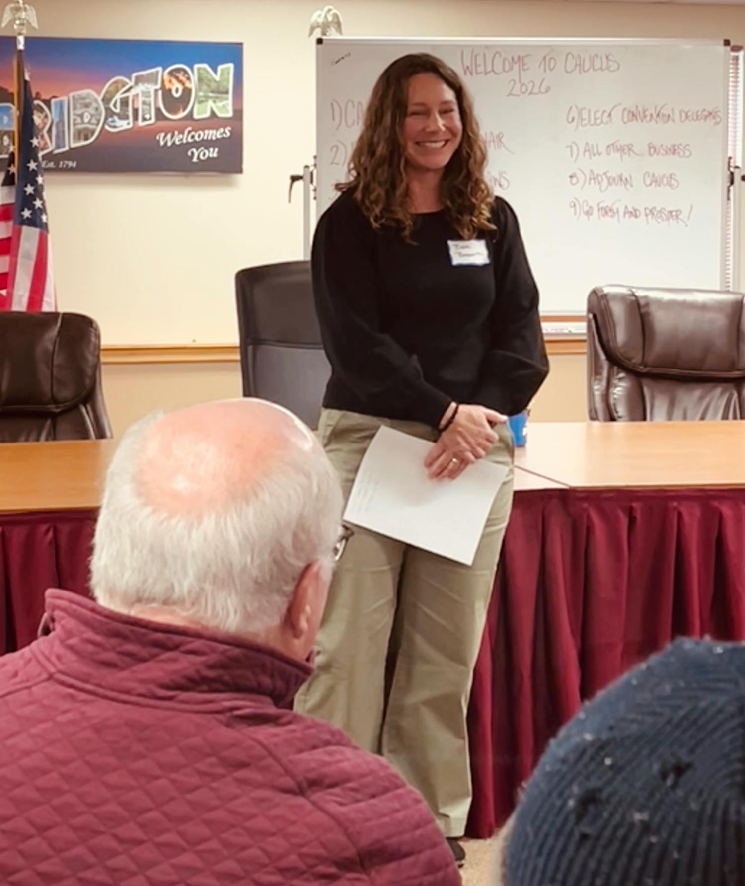 Candidate smiling in front of audience at Bridgton caucus