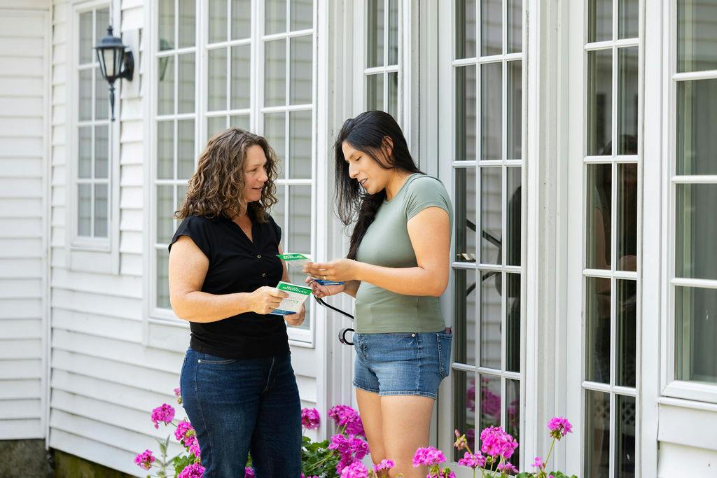 Candidate speaking with person in front of door