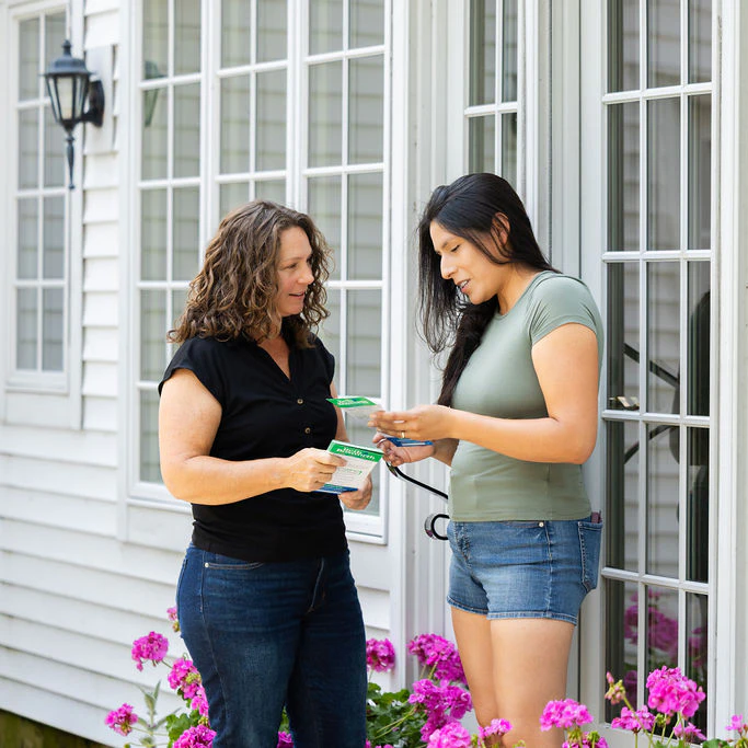 Candidate speaking with person in front of door