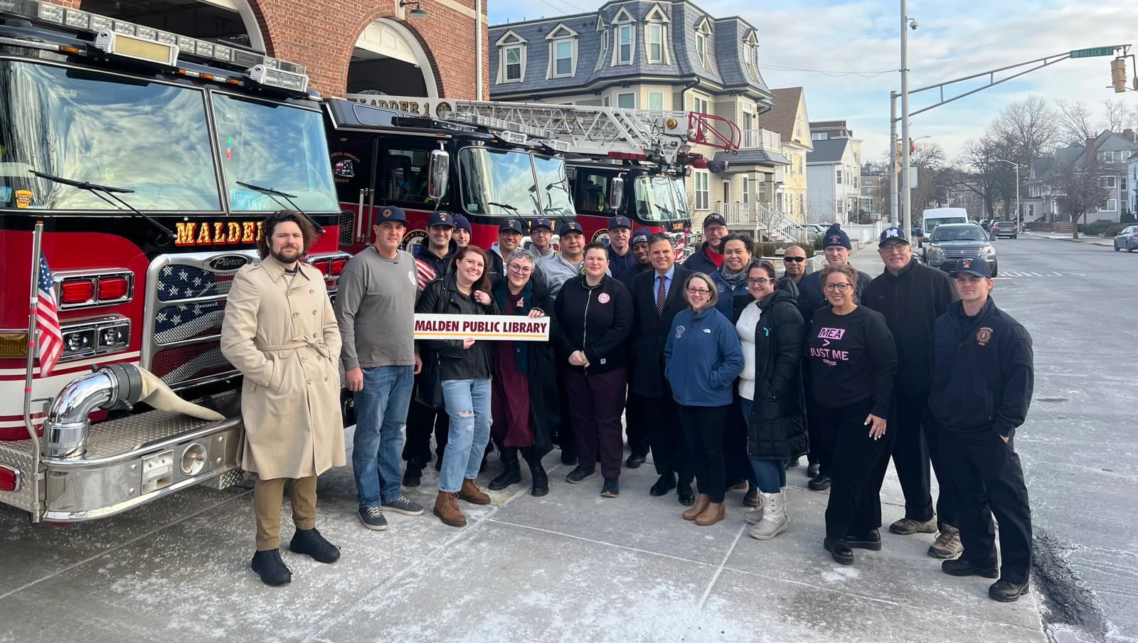 Union workers and elected officials stand in front of the Malden Fire Dept