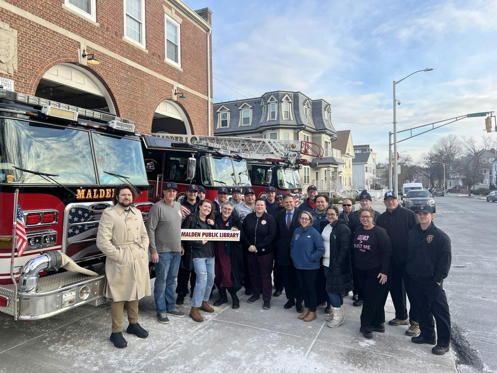 Union workers and elected officials stand in front of the Malden Fire Dept