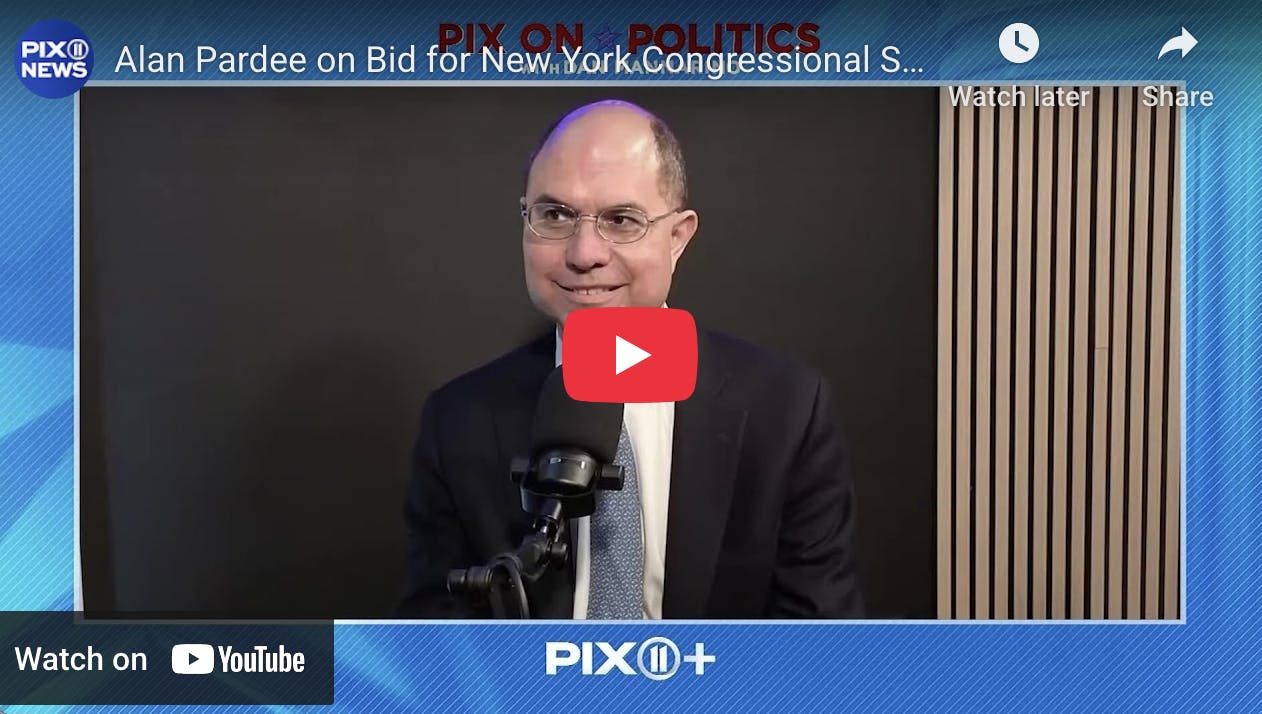 Still of NY-12 candidate Alan Pardee smiling with a news microphone in front of him; red youtube play button is overlayed.