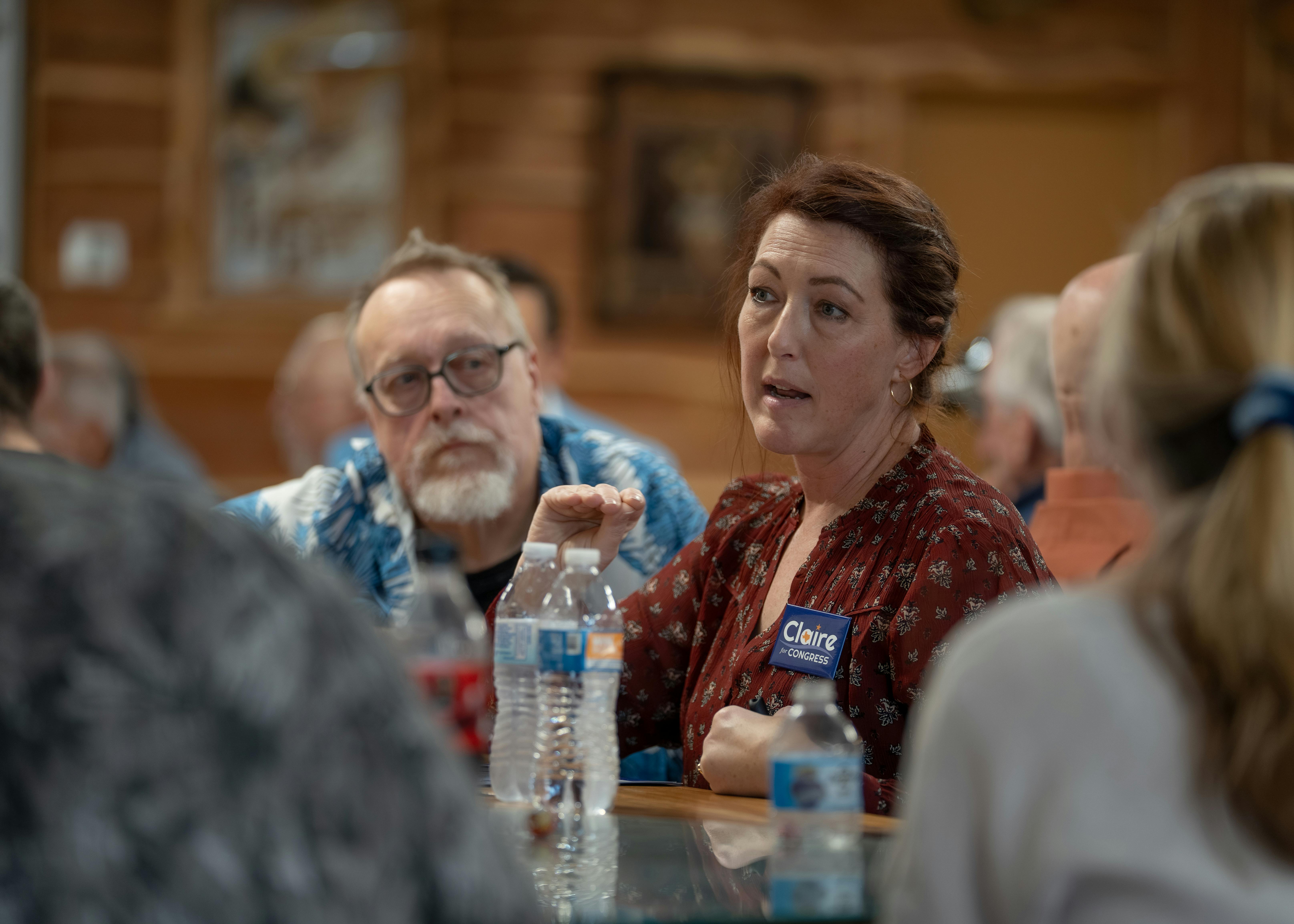 Claire Reynolds in a Speed Campaigning musical chairs event (with an intently focused listener)