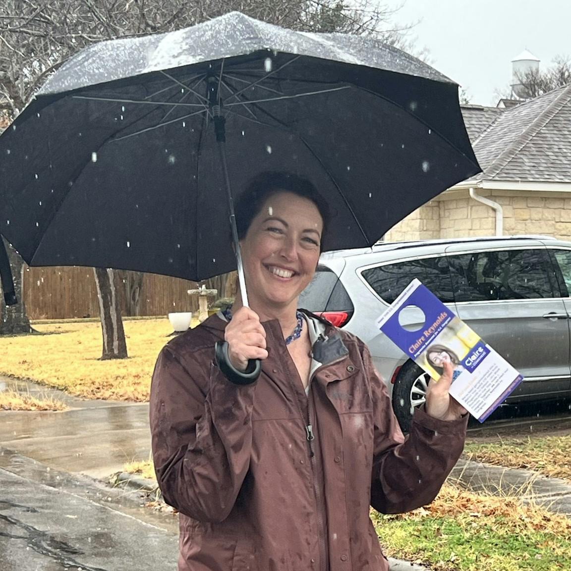 Claire in the rain holding campaign literature
