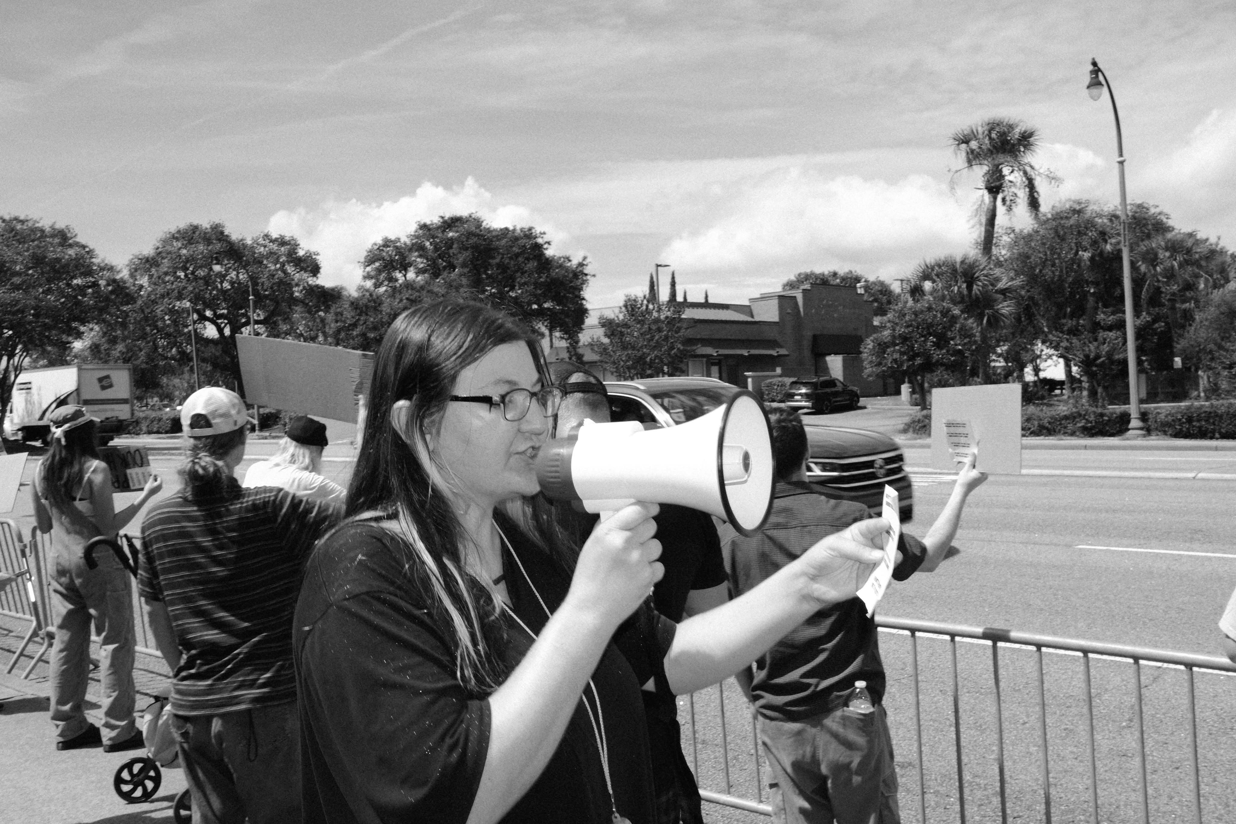 Photo of Marisa speaking into a megaphone