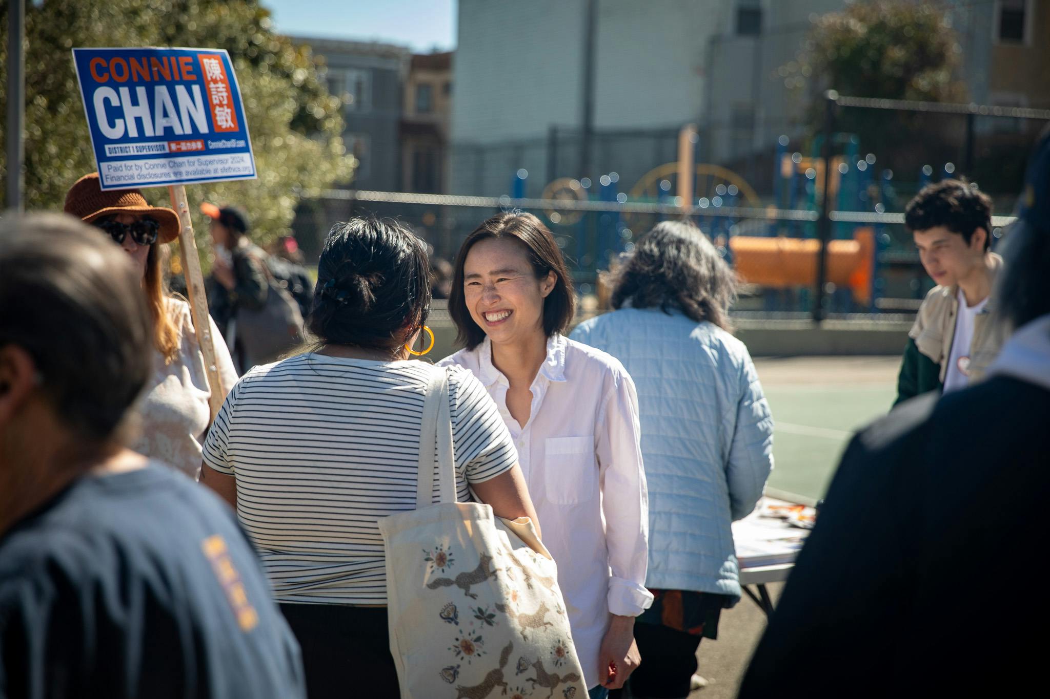 Connie Chan, candidate for Congress, smiling in an outdoor portrait.