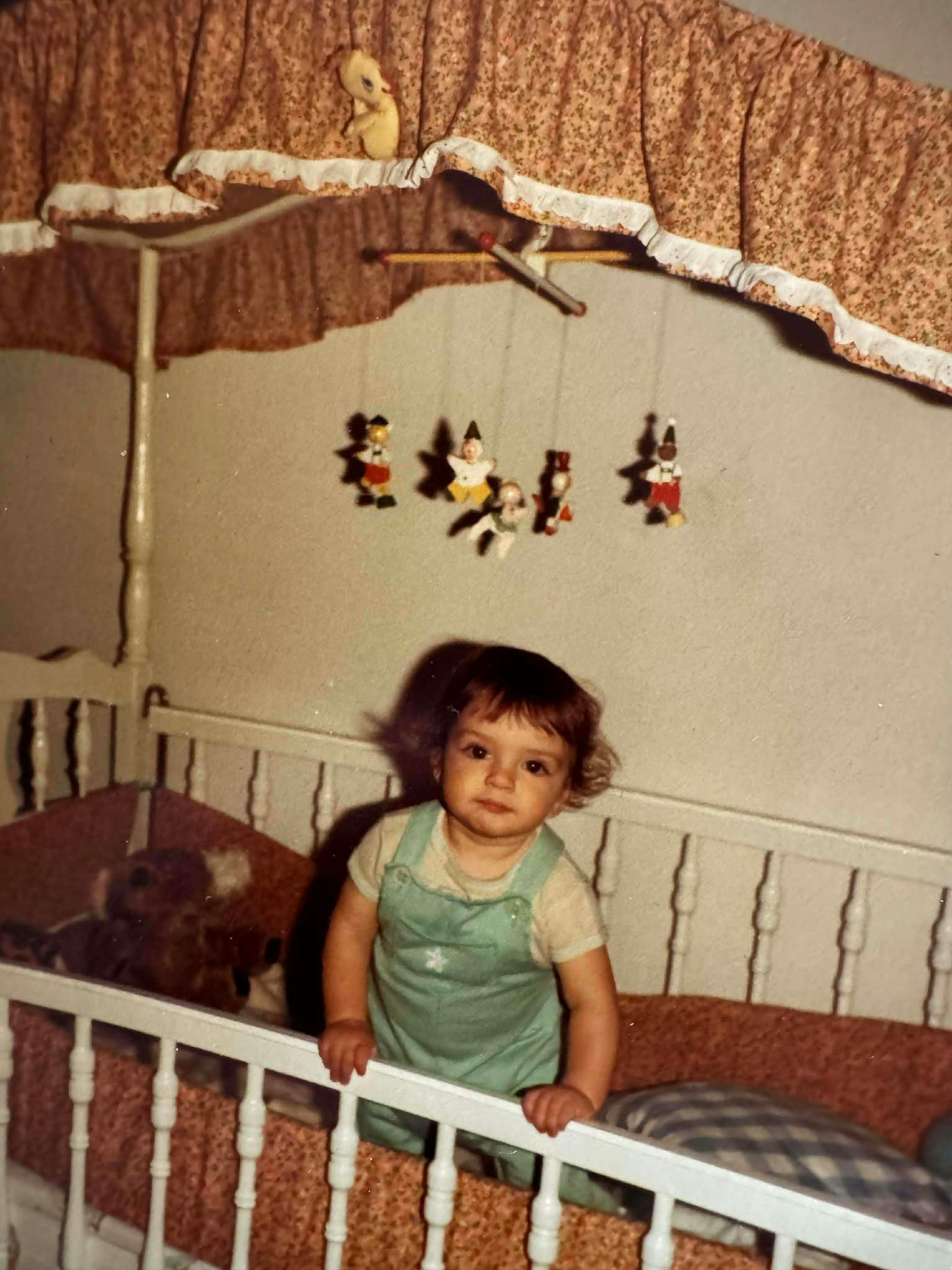 Sarah as a baby in her crib