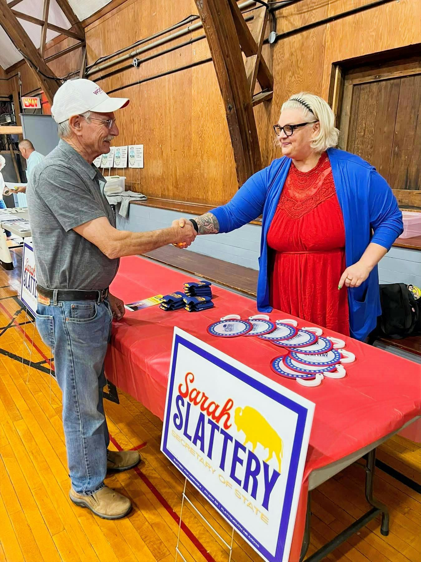 Sarah shaking a voters hand.