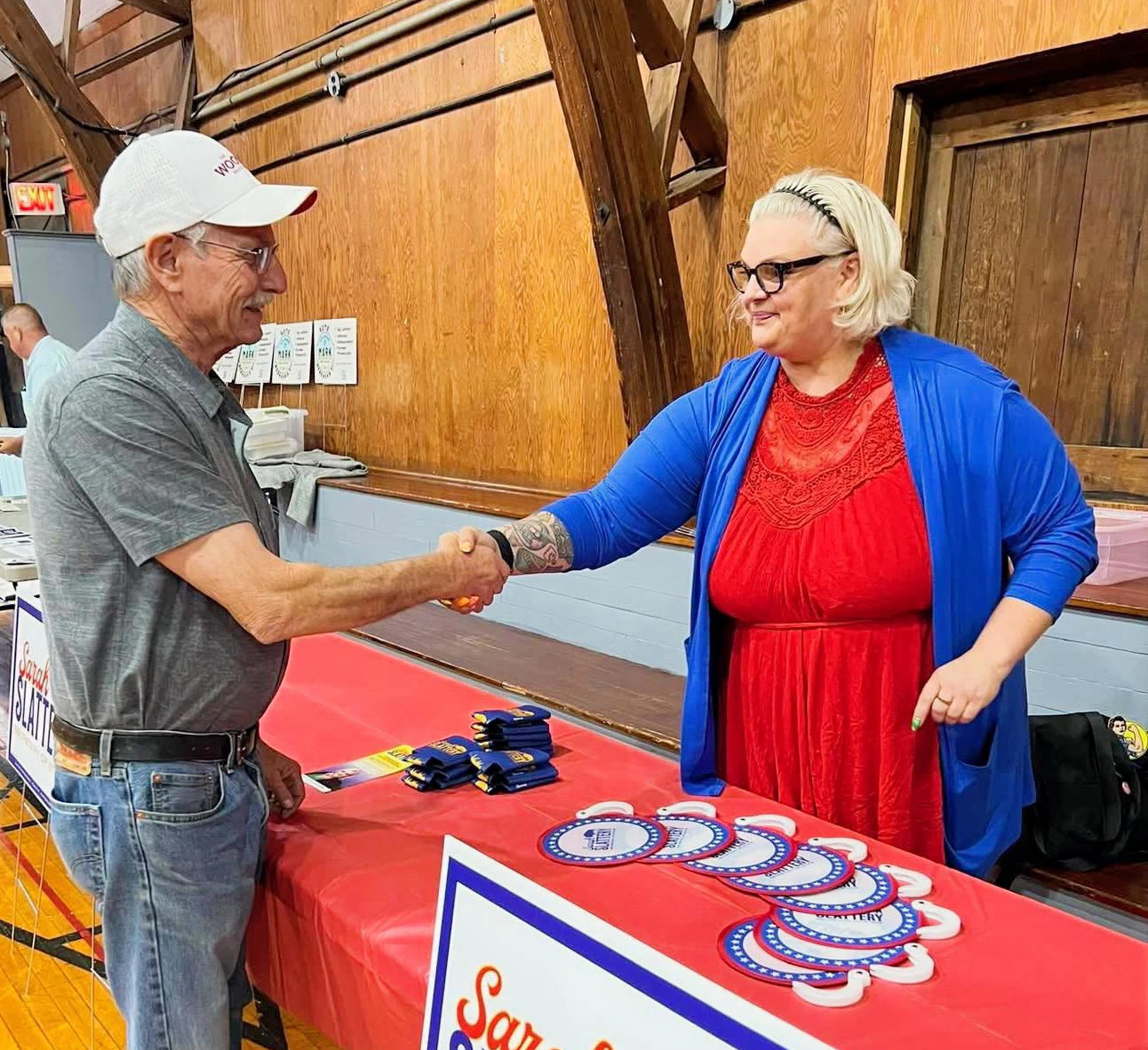 Sarah shaking a voters hand.