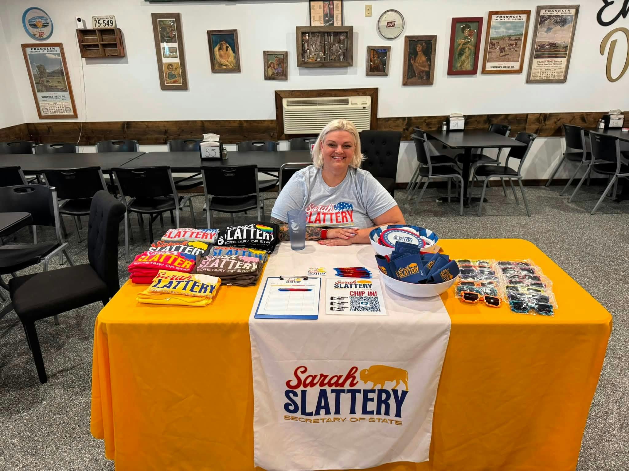 Sarah sitting at the campaign table.