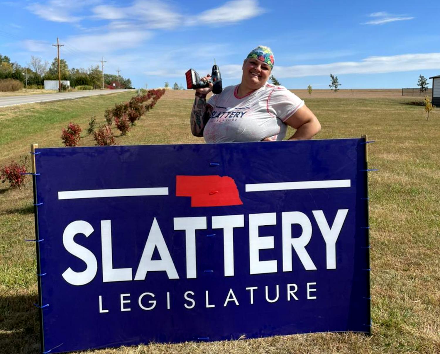 Sarah placing campaign sign