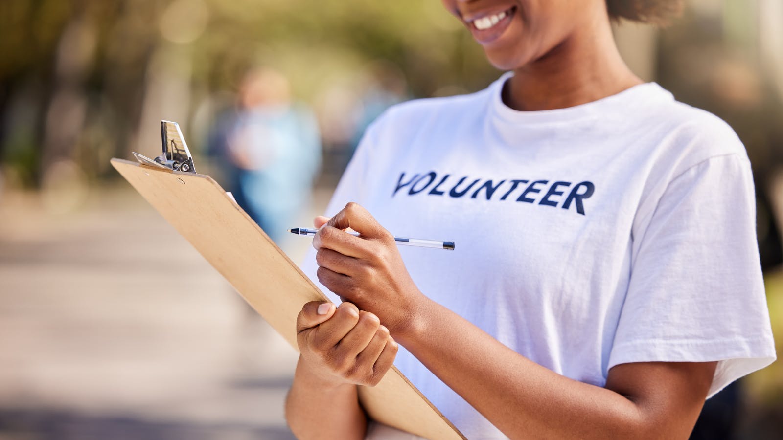 Volunteer signing people up for an event.
