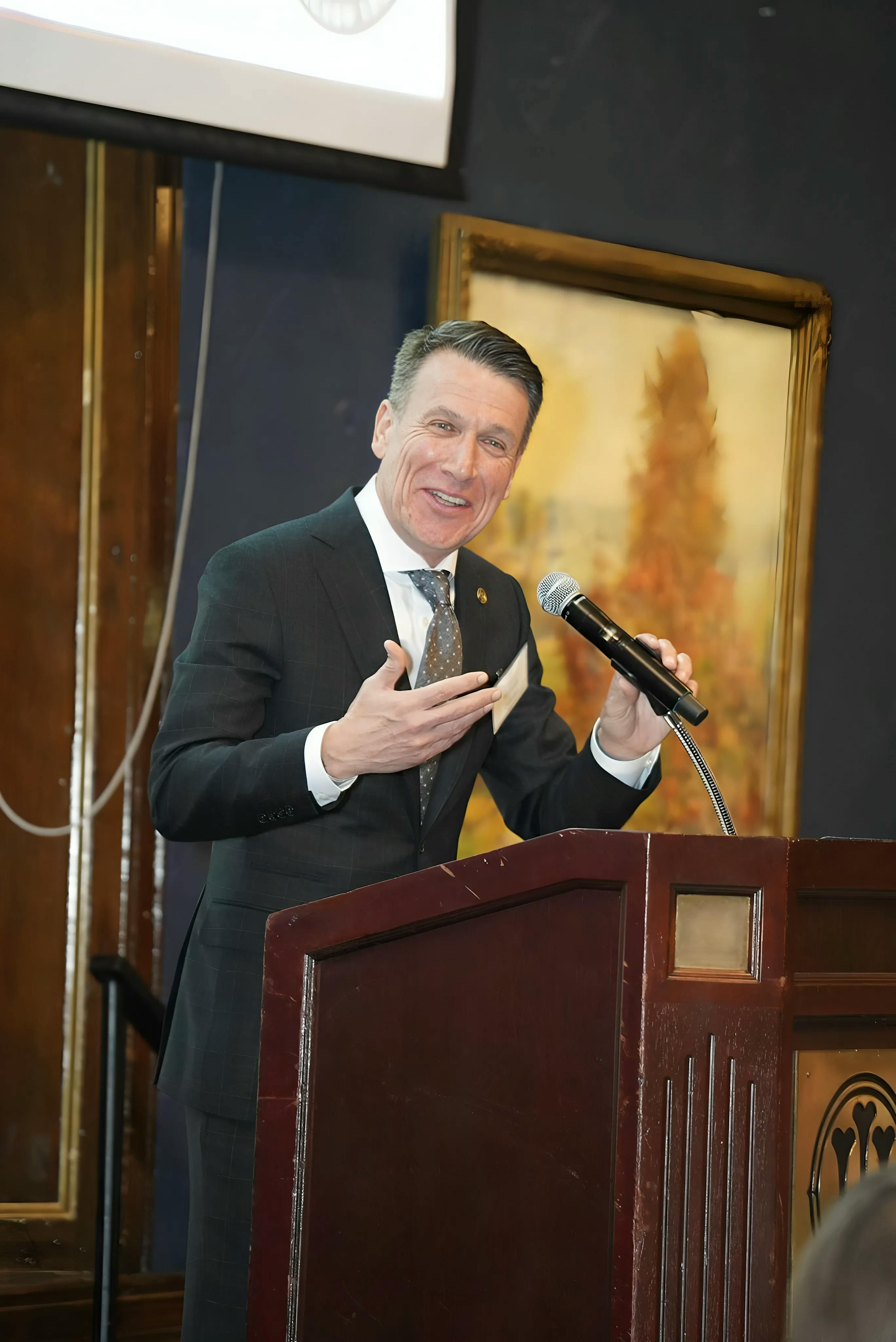 Bill giving a speech at a podium