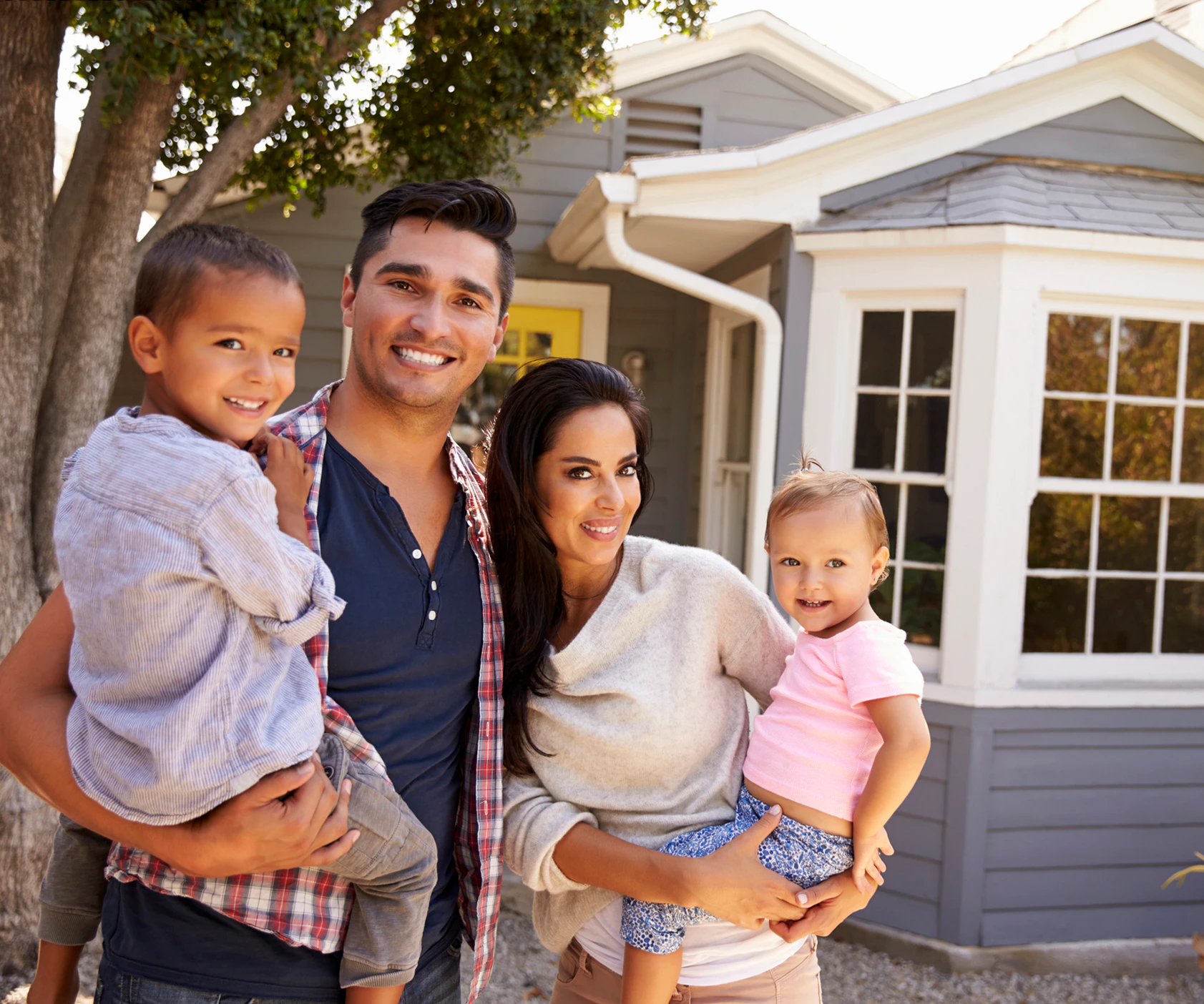 Portrait of family in front of home