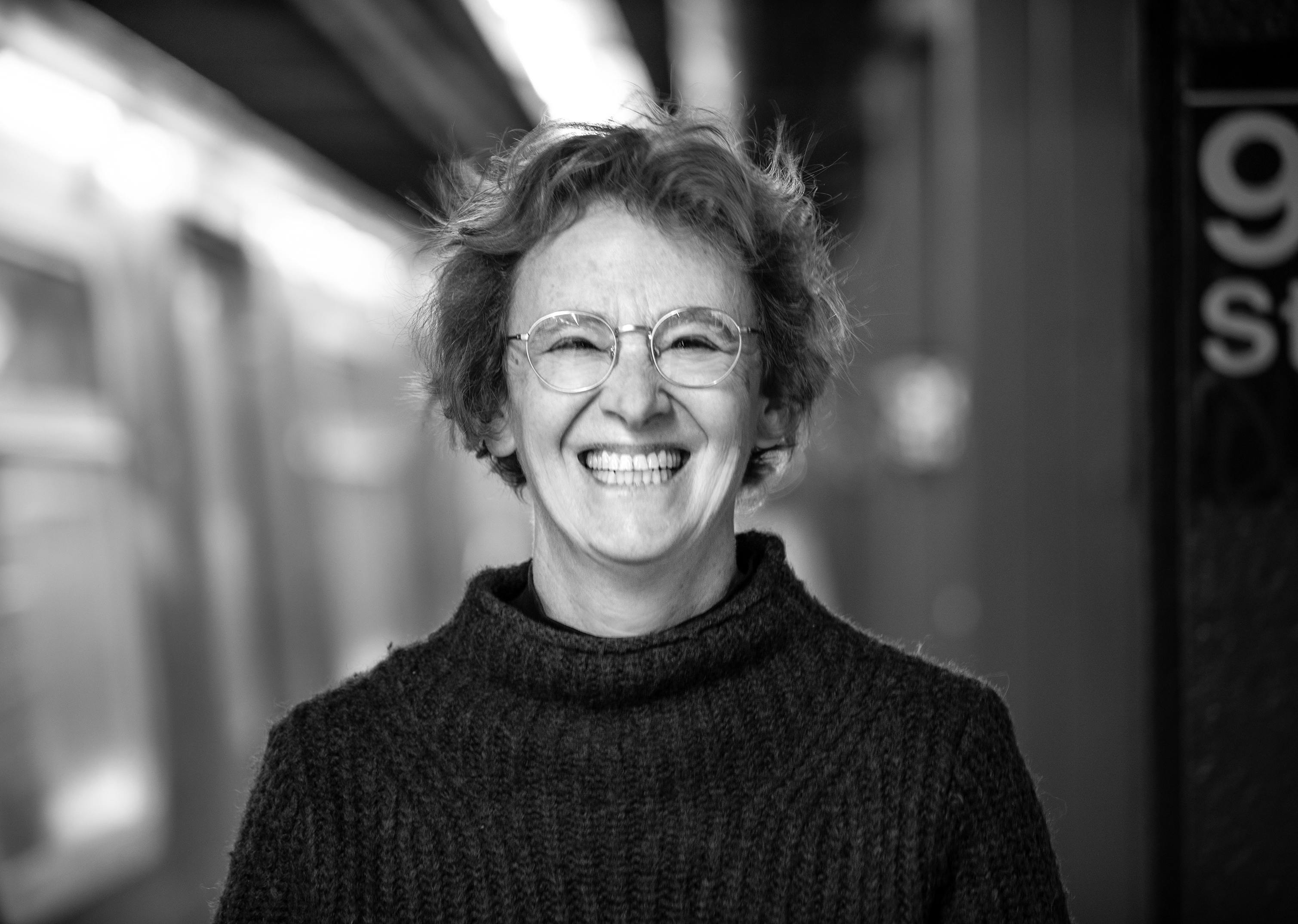 Black and white portrait of Nina with a big smile