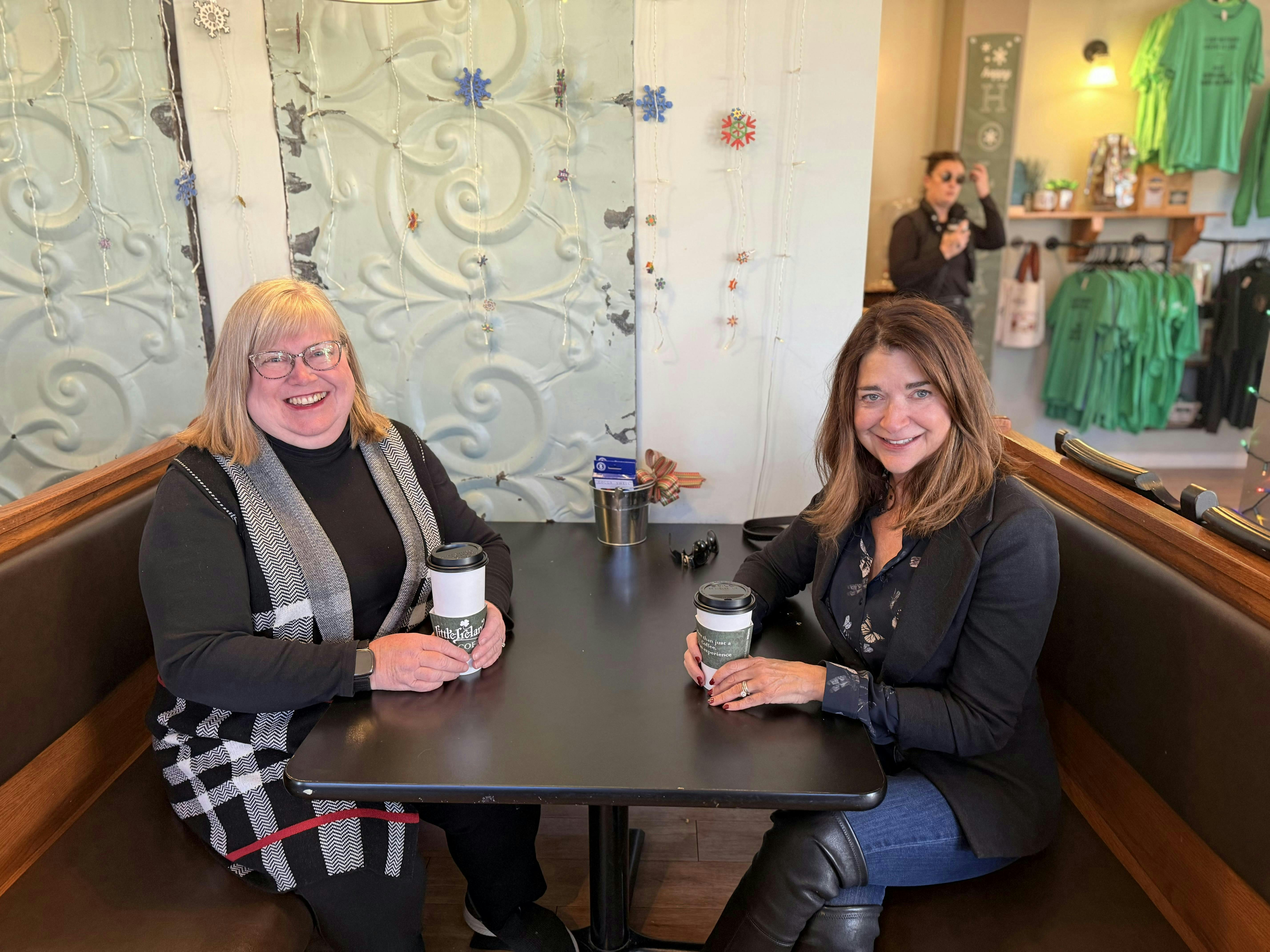 Joan enjoying conversation and coffee