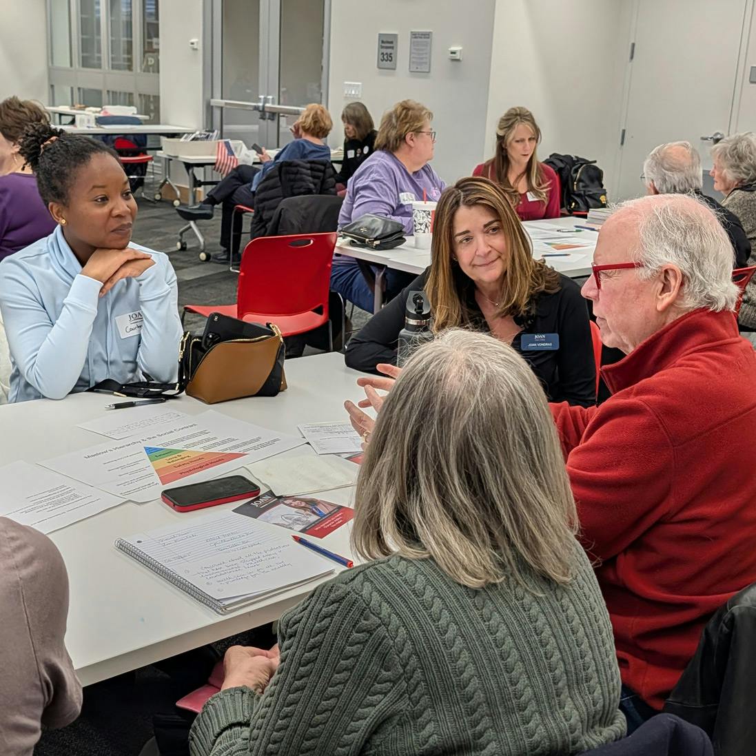 Photo of Joan VonDras in conversation with community members