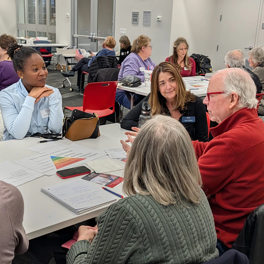 Photo of Joan VonDras in conversation with community members