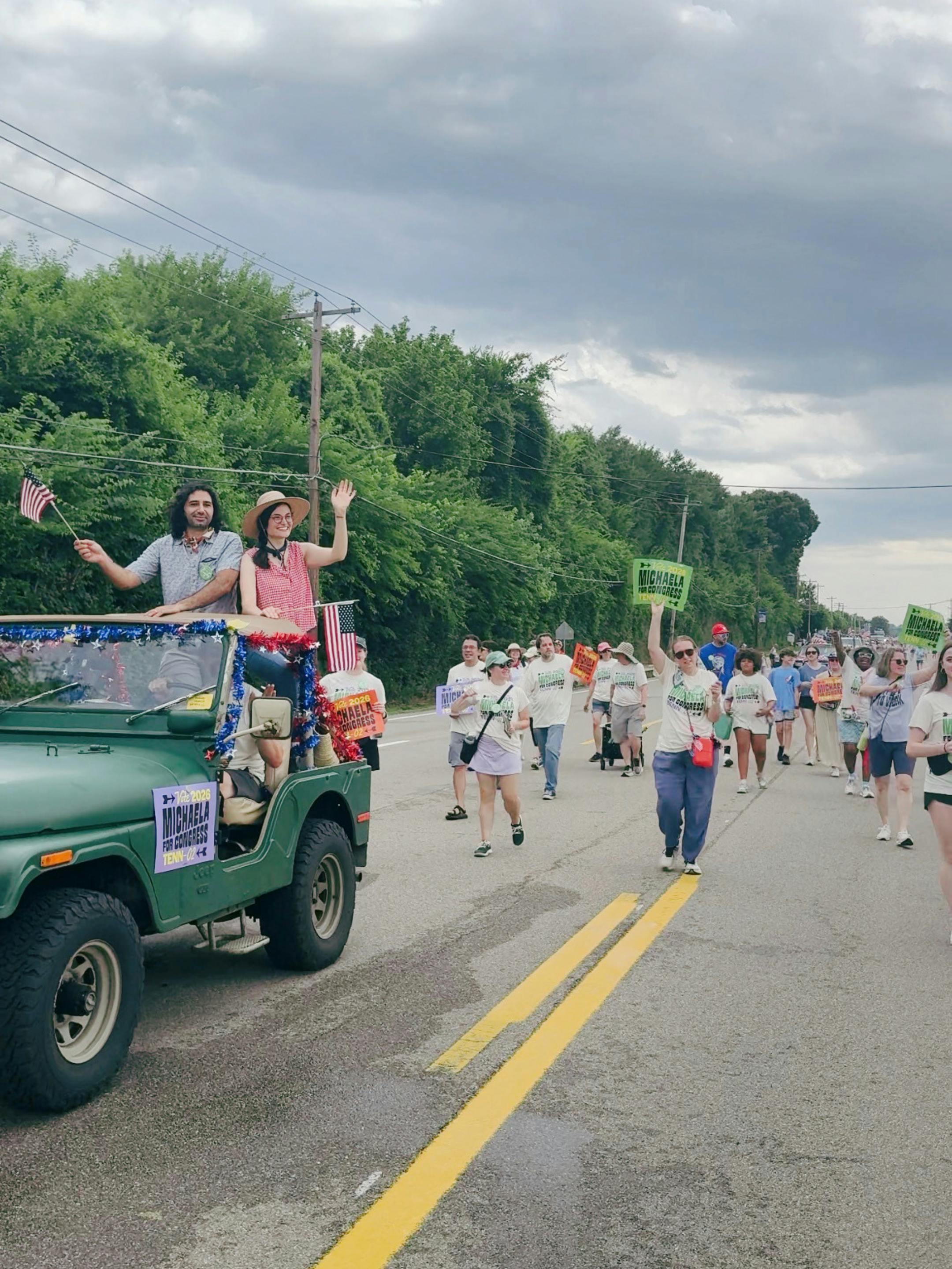portrait of Michaela Barnett in a jeep on a parade route with supporters