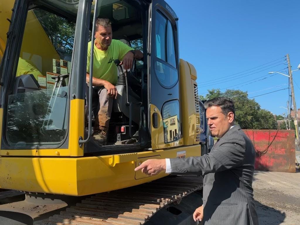 Mayor Christenson speaking with a City Employee in an earth mover at a Construction Site