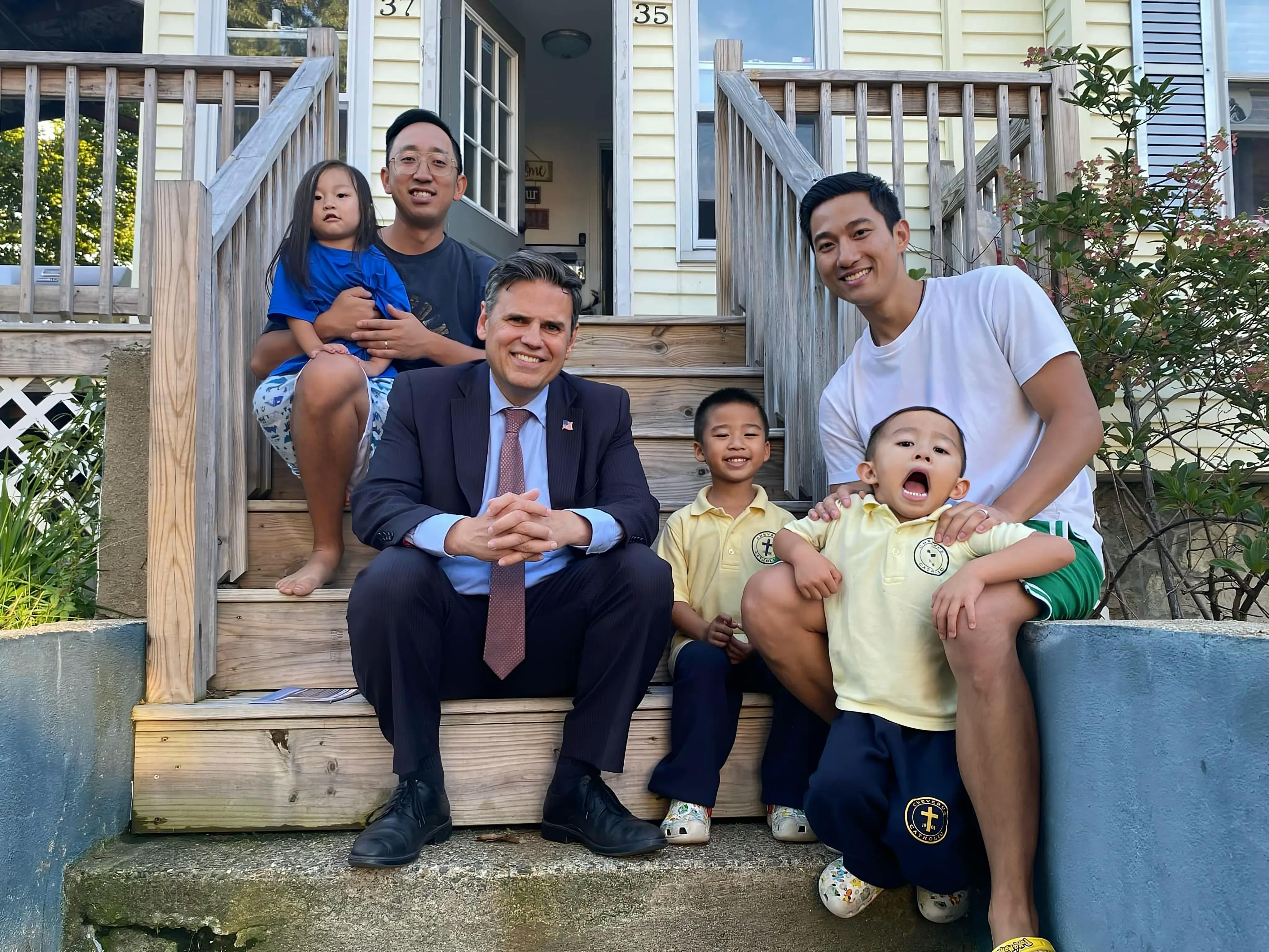 Mayor Christenson with two Asian-American men and three children