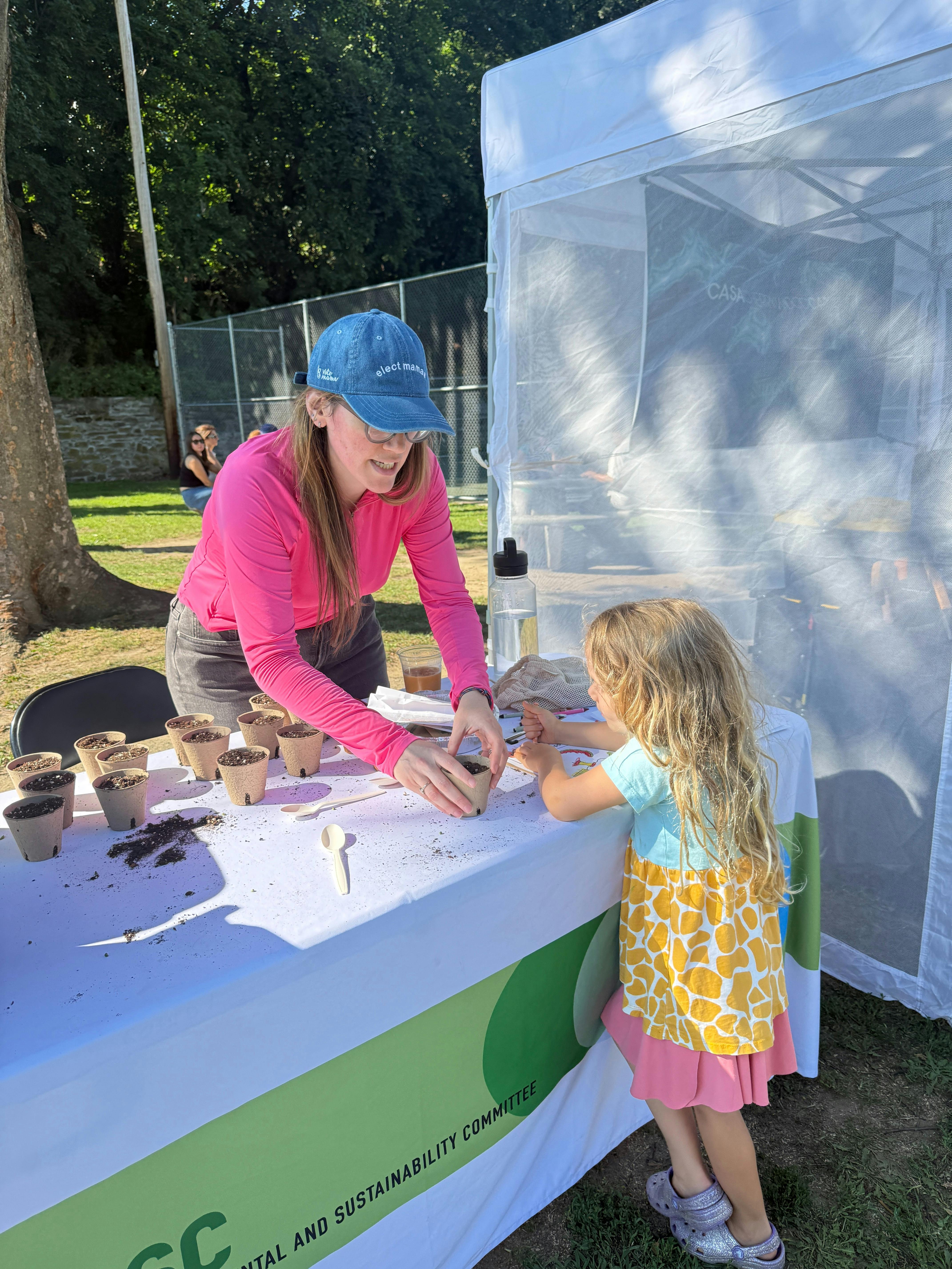 Candidate planting with a child for Tuckahoe Environmental Committee