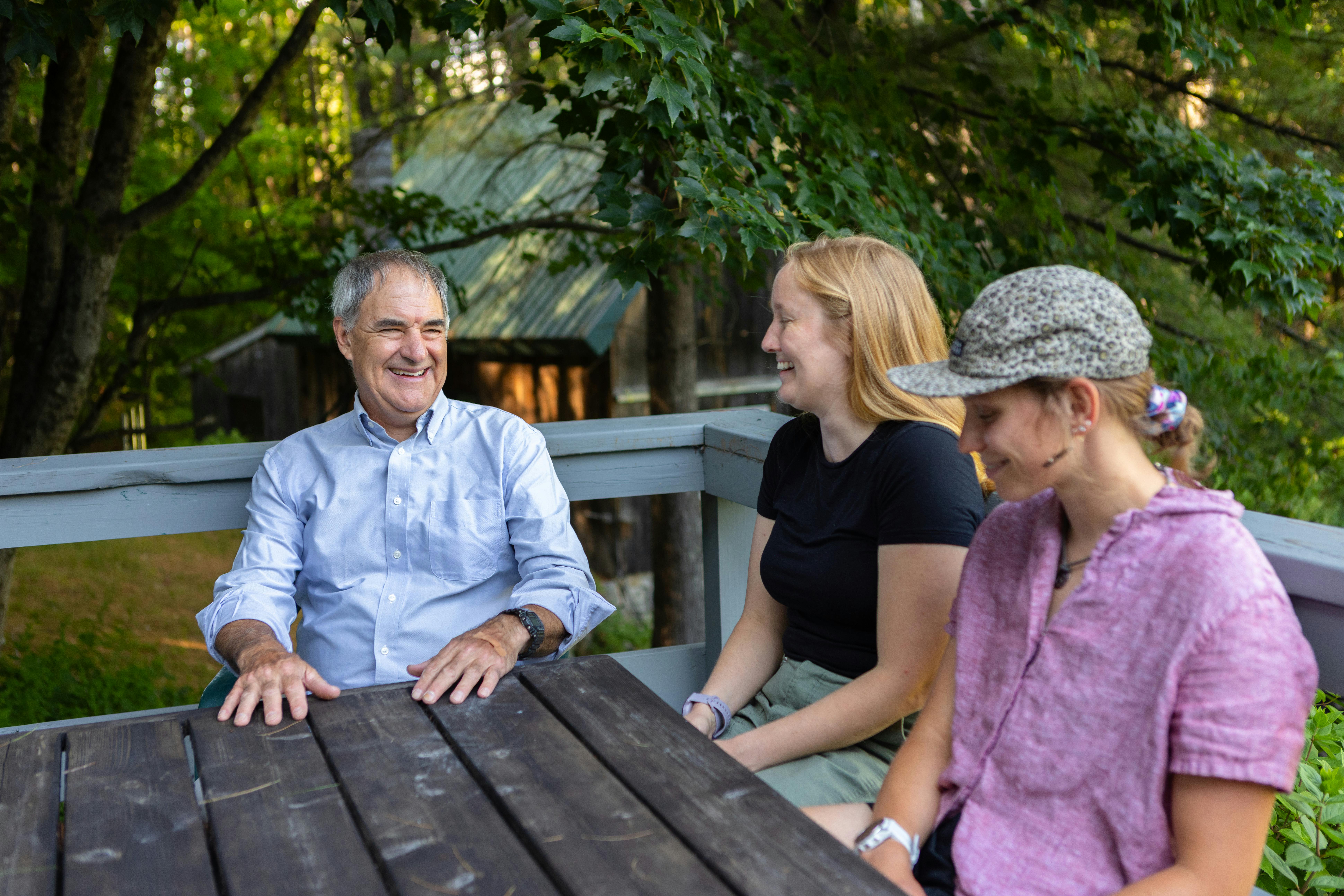 Candidate at outside table with two young women