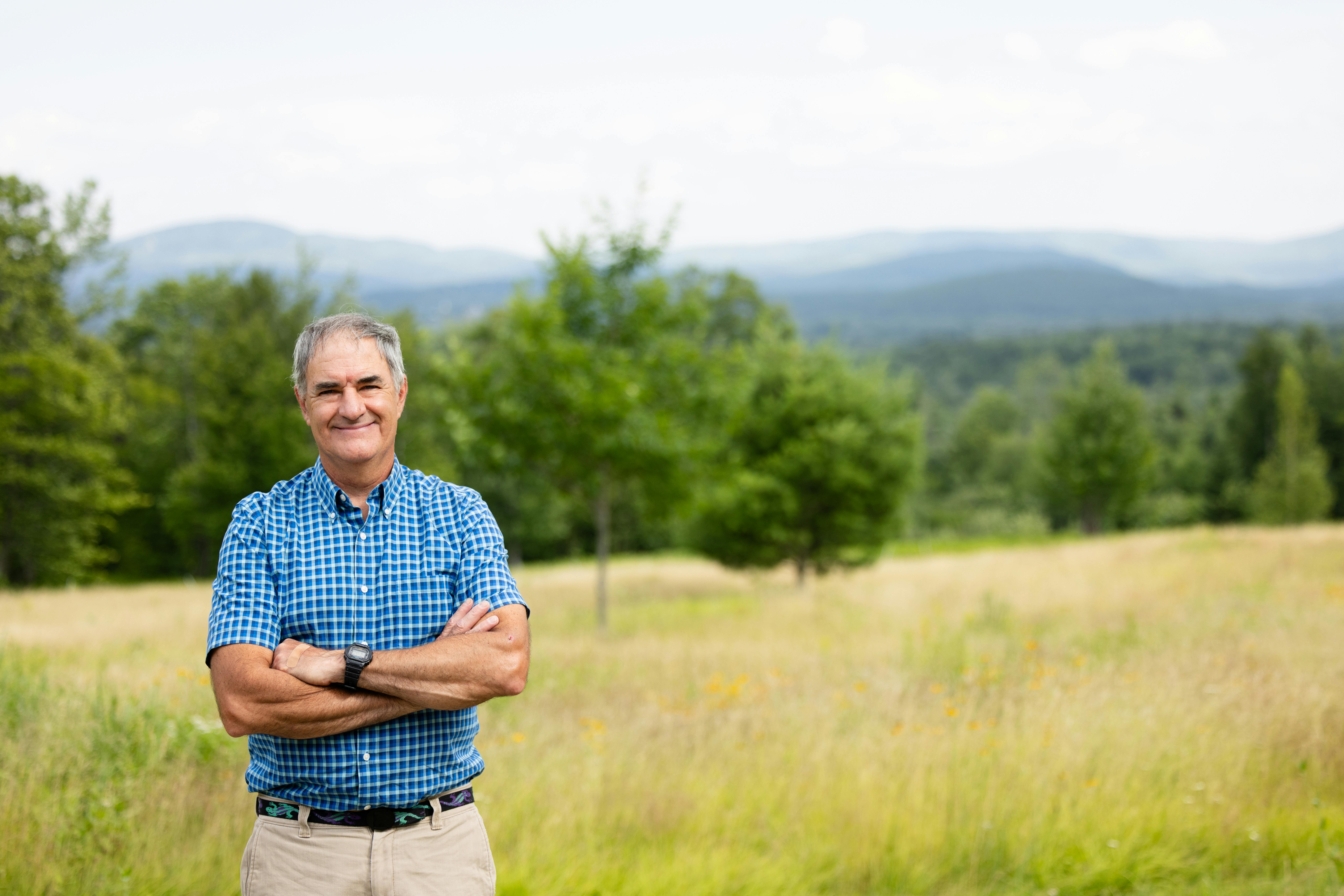 Portrait of candidate smiling with valley and mountains in background