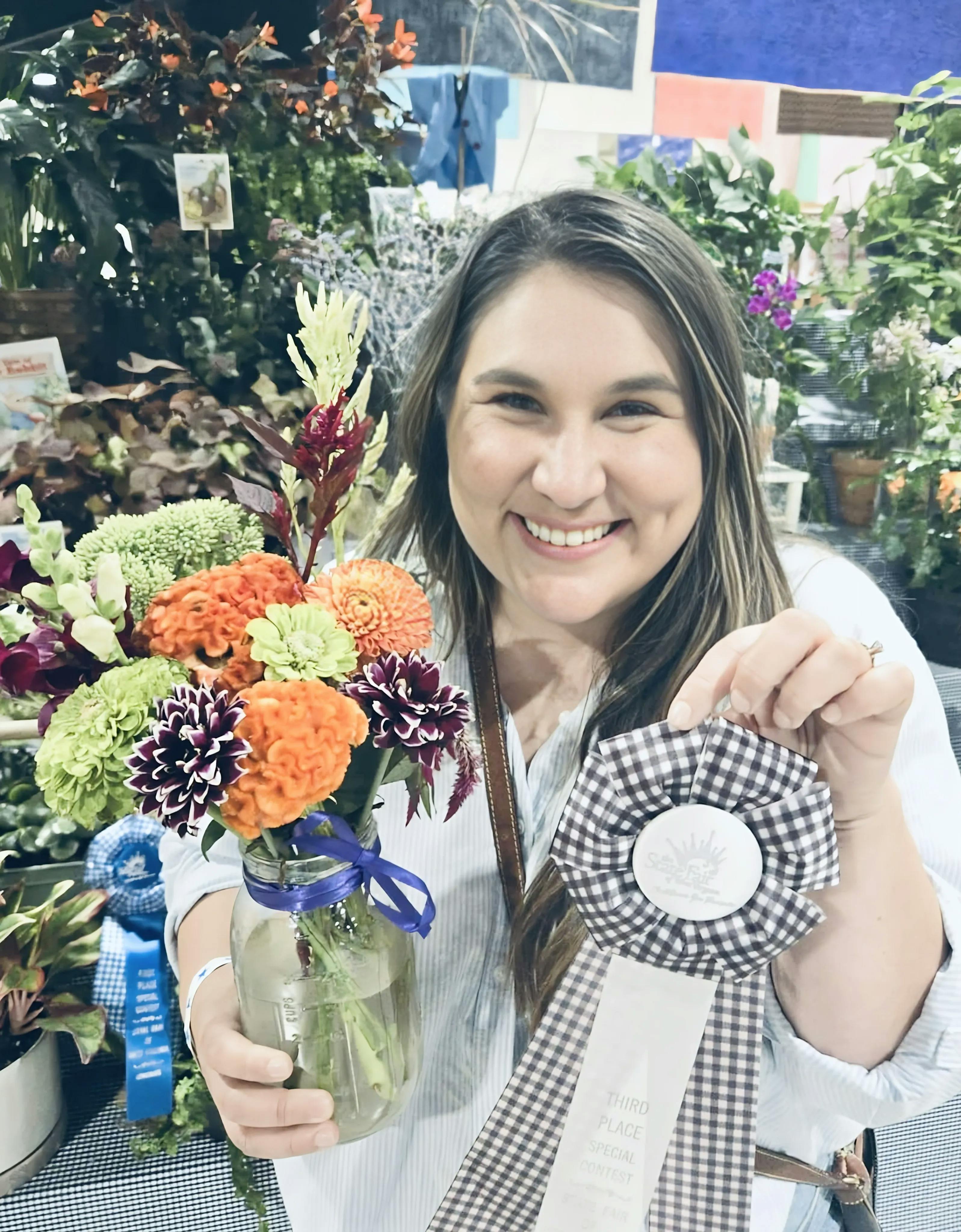 Sarah holding her flowers and award from the WV State Fair.