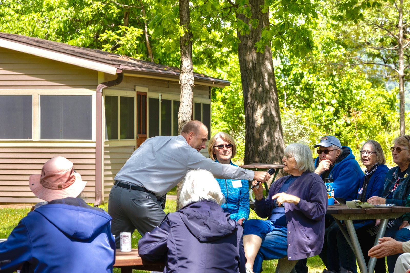 Jake Johnson greeting voters at an outdoor gathering in southern Minnesota