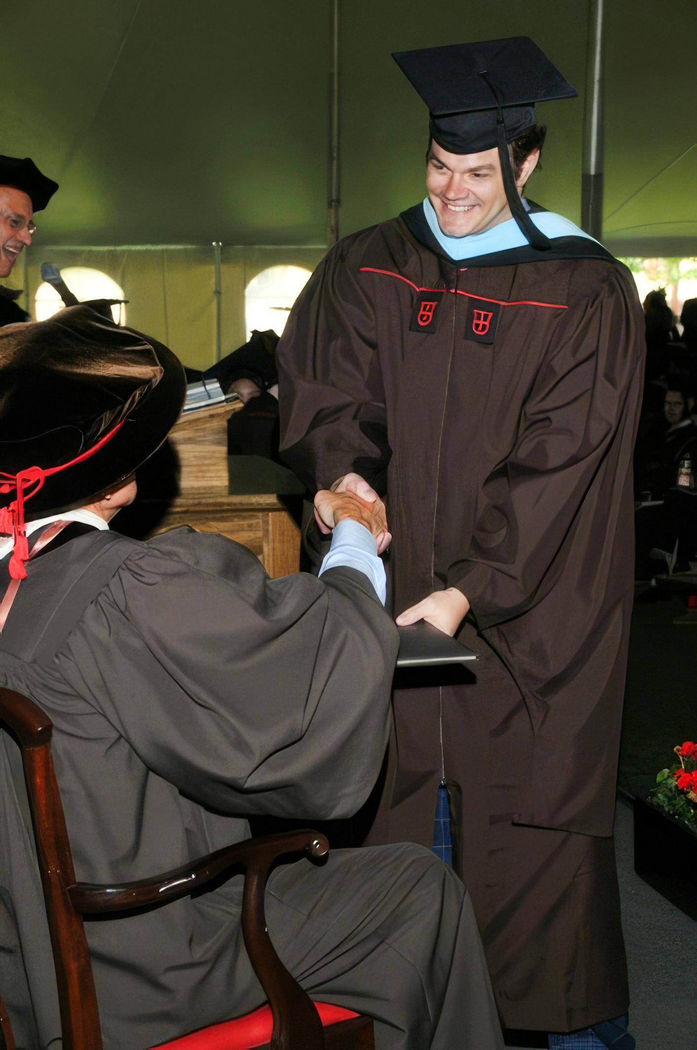 Edward Brown receiving diploma at graduation ceremony