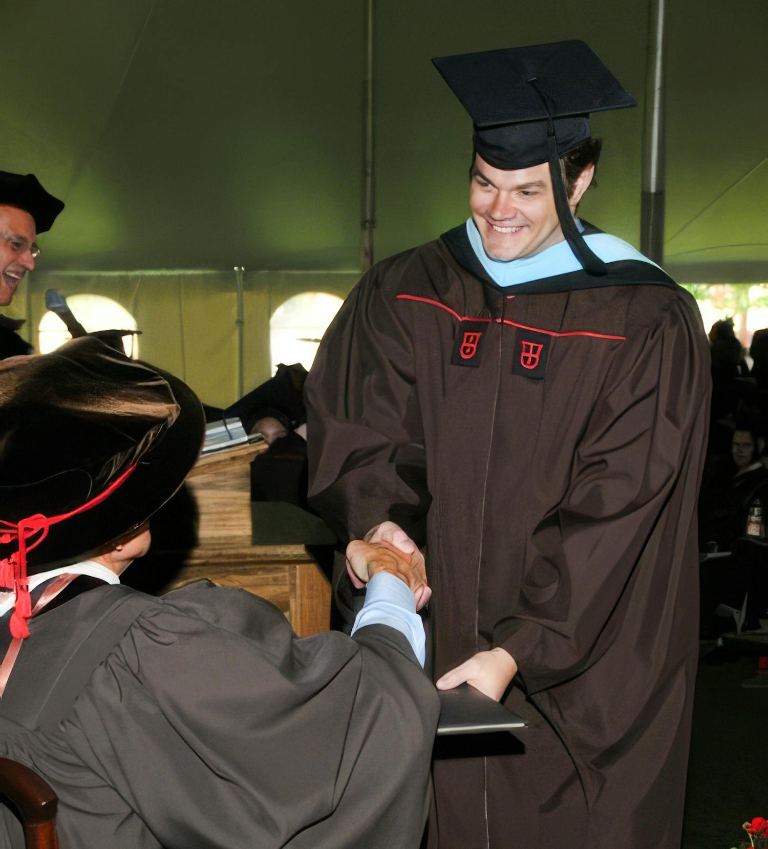Edward Brown receiving diploma at graduation ceremony