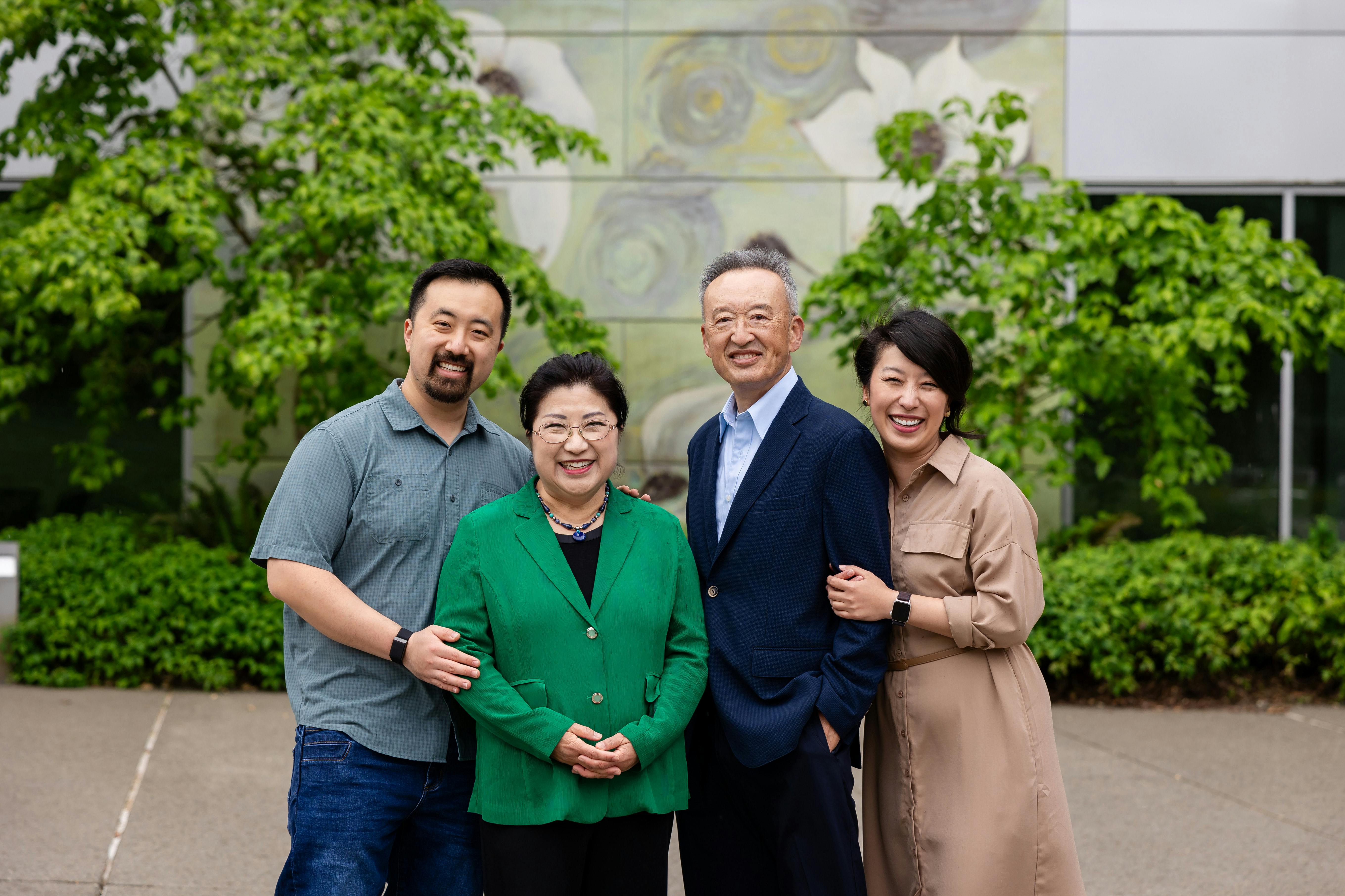 photo of Cindy Ryu standing at a microhpone surrounded by supporters