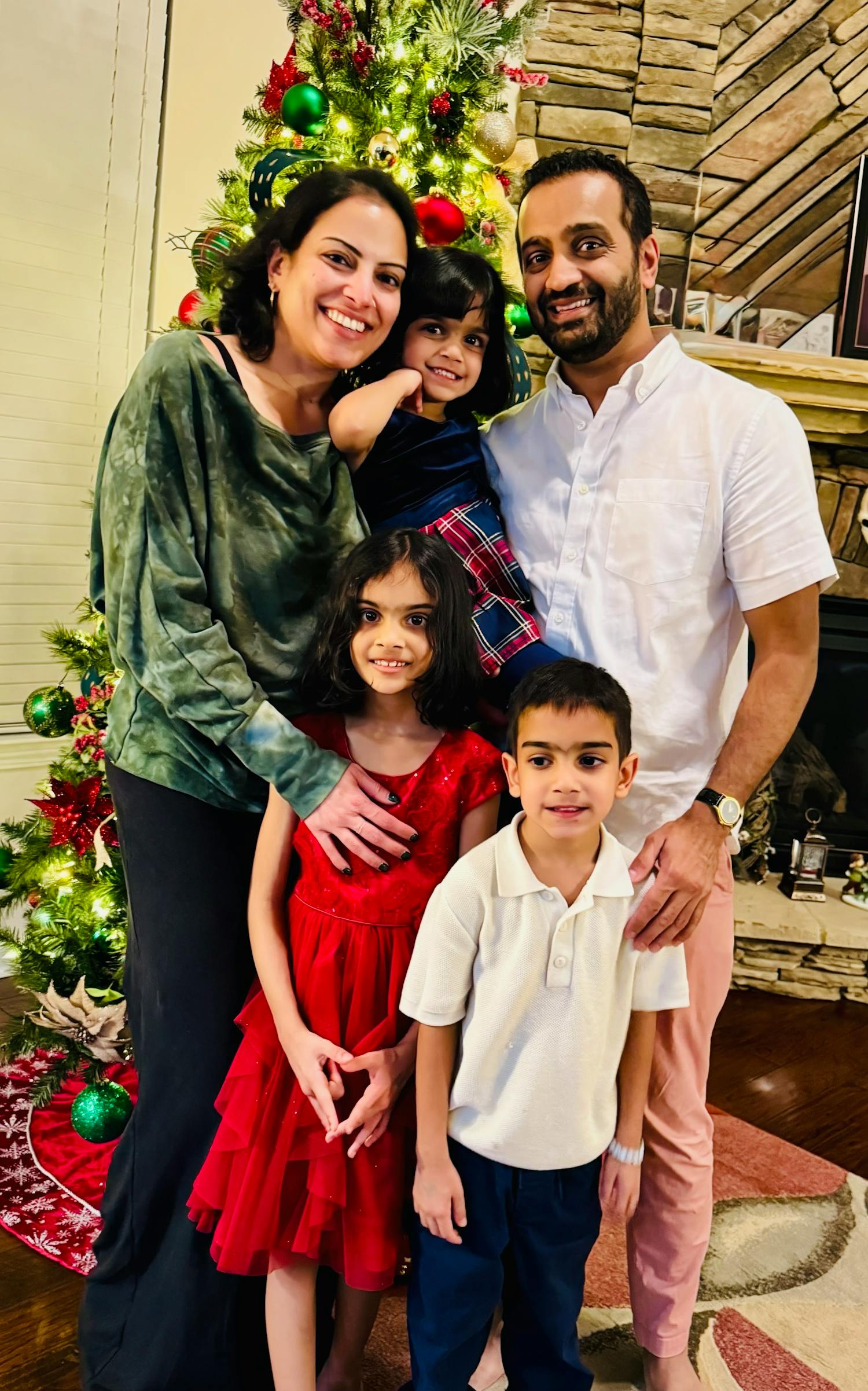 Portrait of candidate and her family in front of a Christmas tree and fireplace