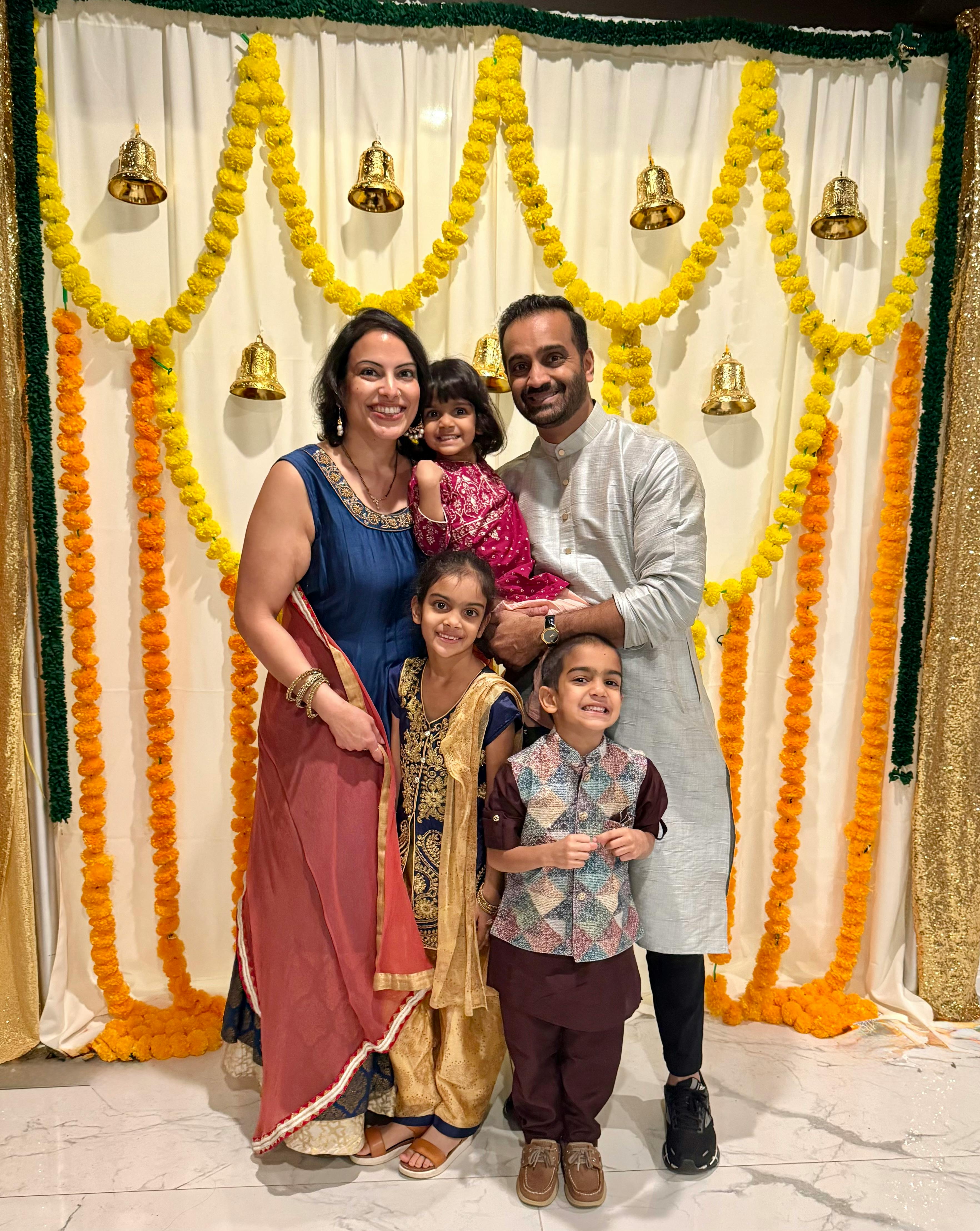 Photo of candidate and her family dressed in traditional festive Indian clothing