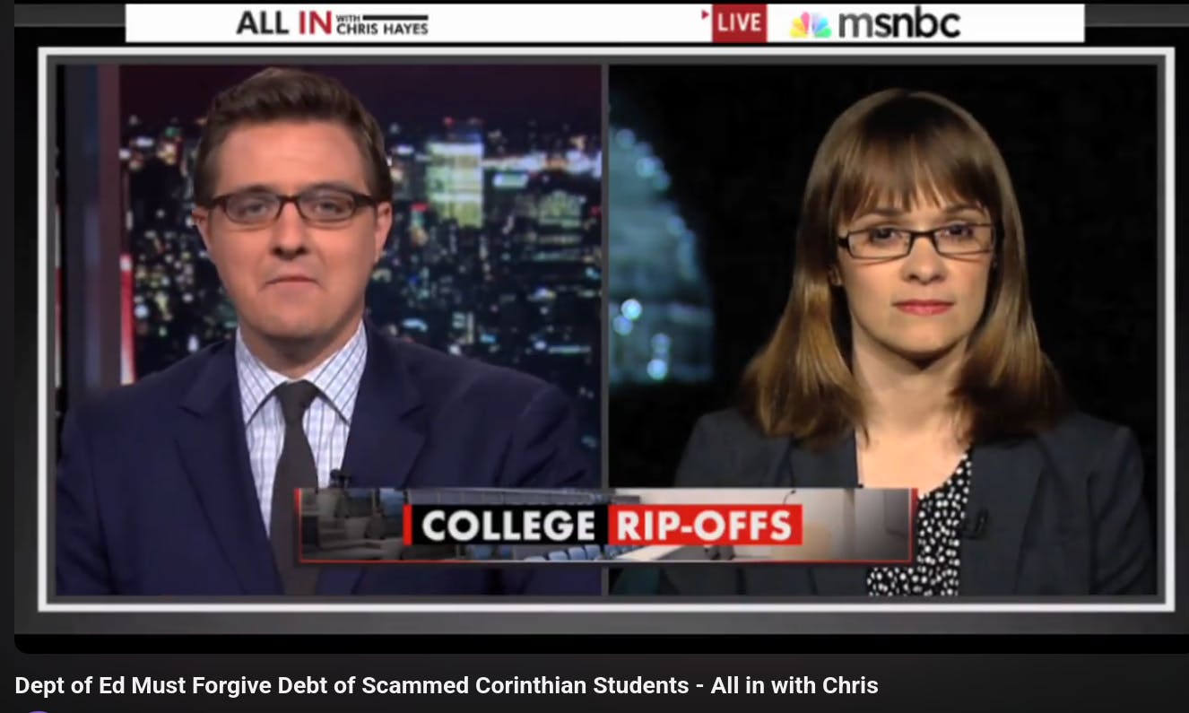 Chris Hayes wearing a suit and tie on the left of the screen, with Alexis Goldstein wearing a navy blue suit blazer and glasses on the right, in front of the U.S. capital, during a segment on All In with Chris Hayes, an MSNBC show