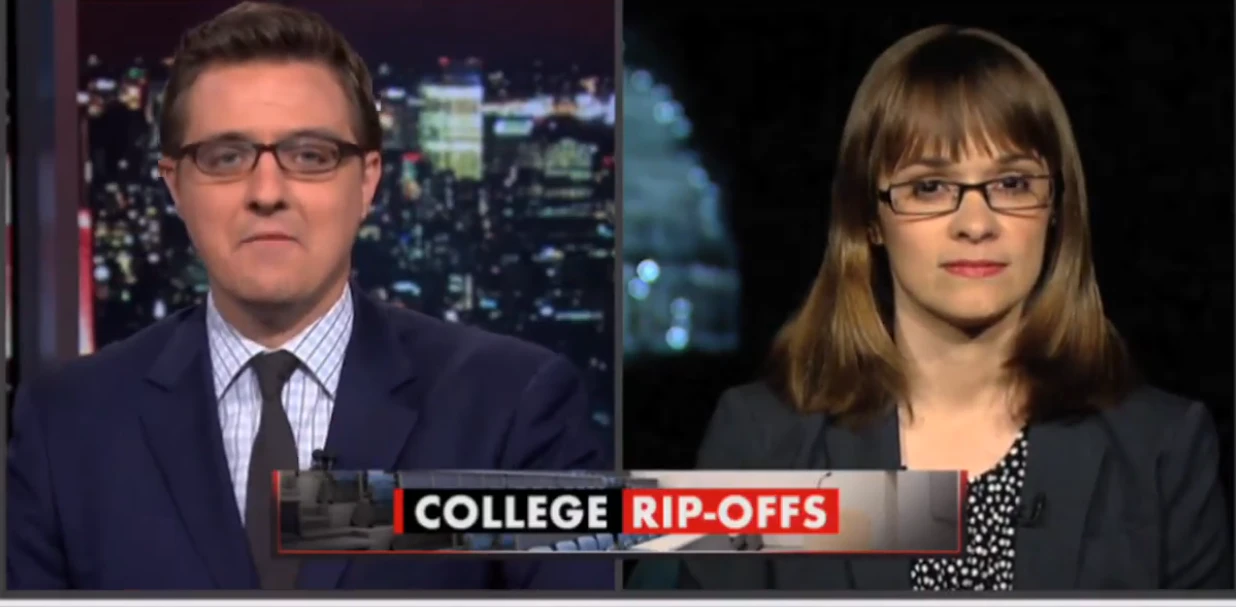 Chris Hayes wearing a suit and tie on the left of the screen, with Alexis Goldstein wearing a navy blue suit blazer and glasses on the right, in front of the U.S. capital, during a segment on All In with Chris Hayes, an MSNBC show